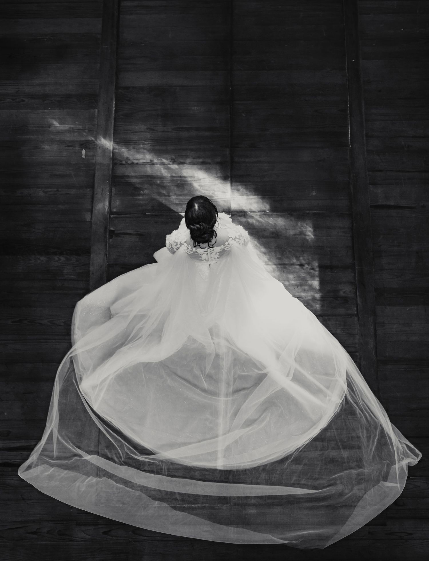 A figure in a flowing white dress appears to float against a dark background with dramatic orange lighting.