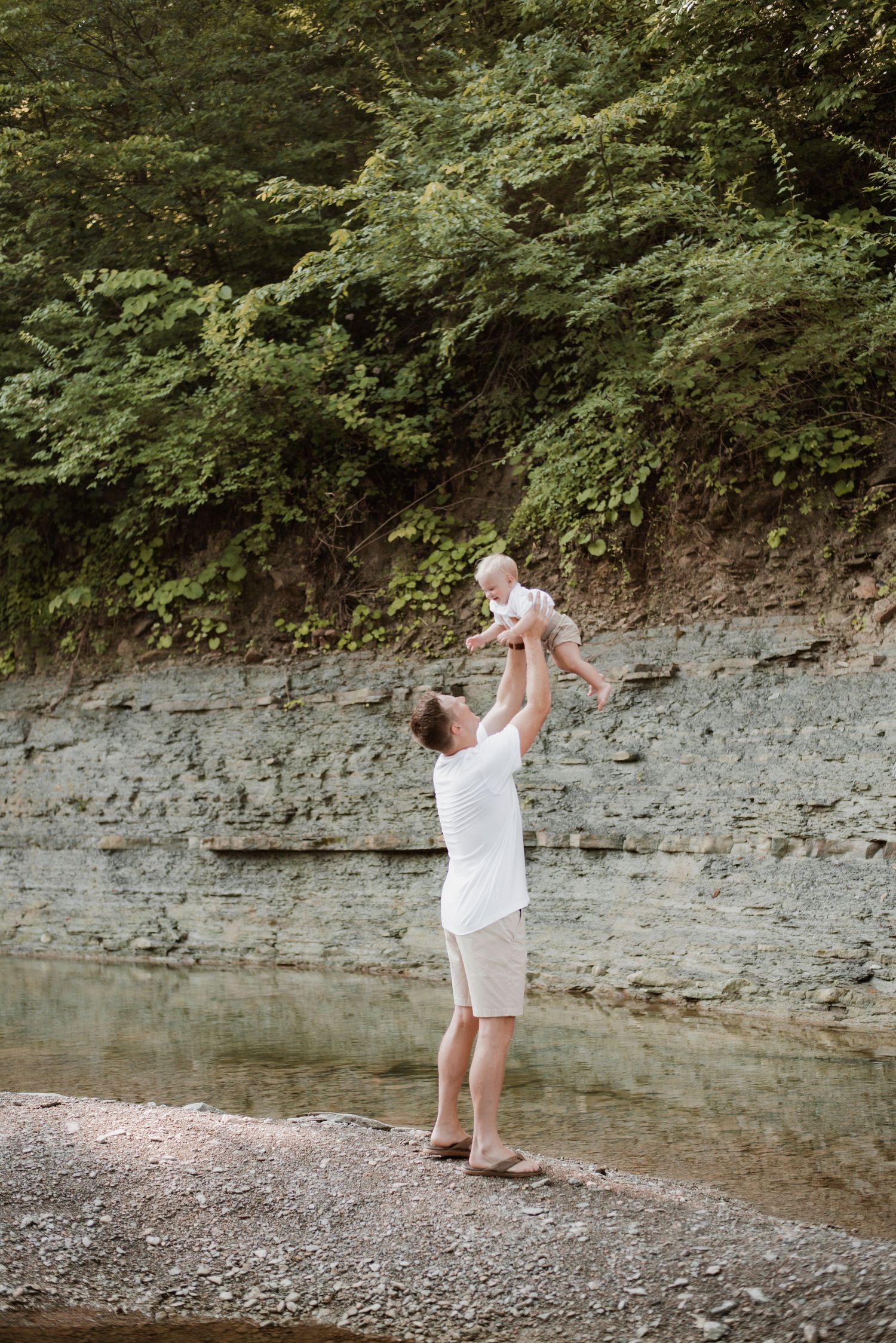 A father holding up his son in the air.