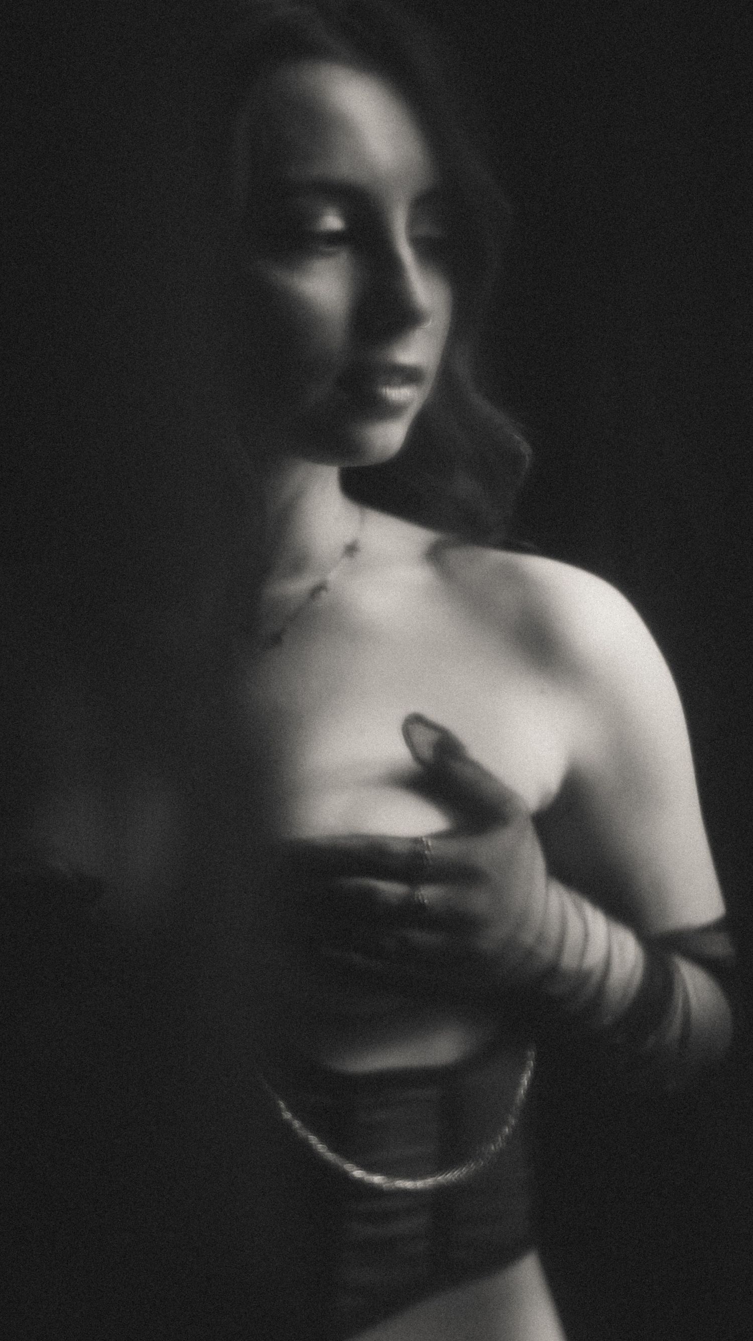 Moody black and white portrait showcasing elegant lingerie silhouettes.