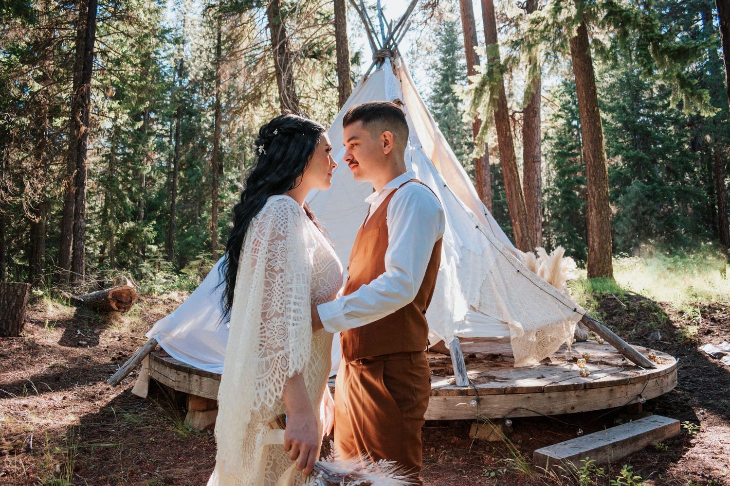 A beautifully styled boho teepee adorned with pillows, macrame, and florals, perfect for whimsical engagement or wedding Mount Rainier