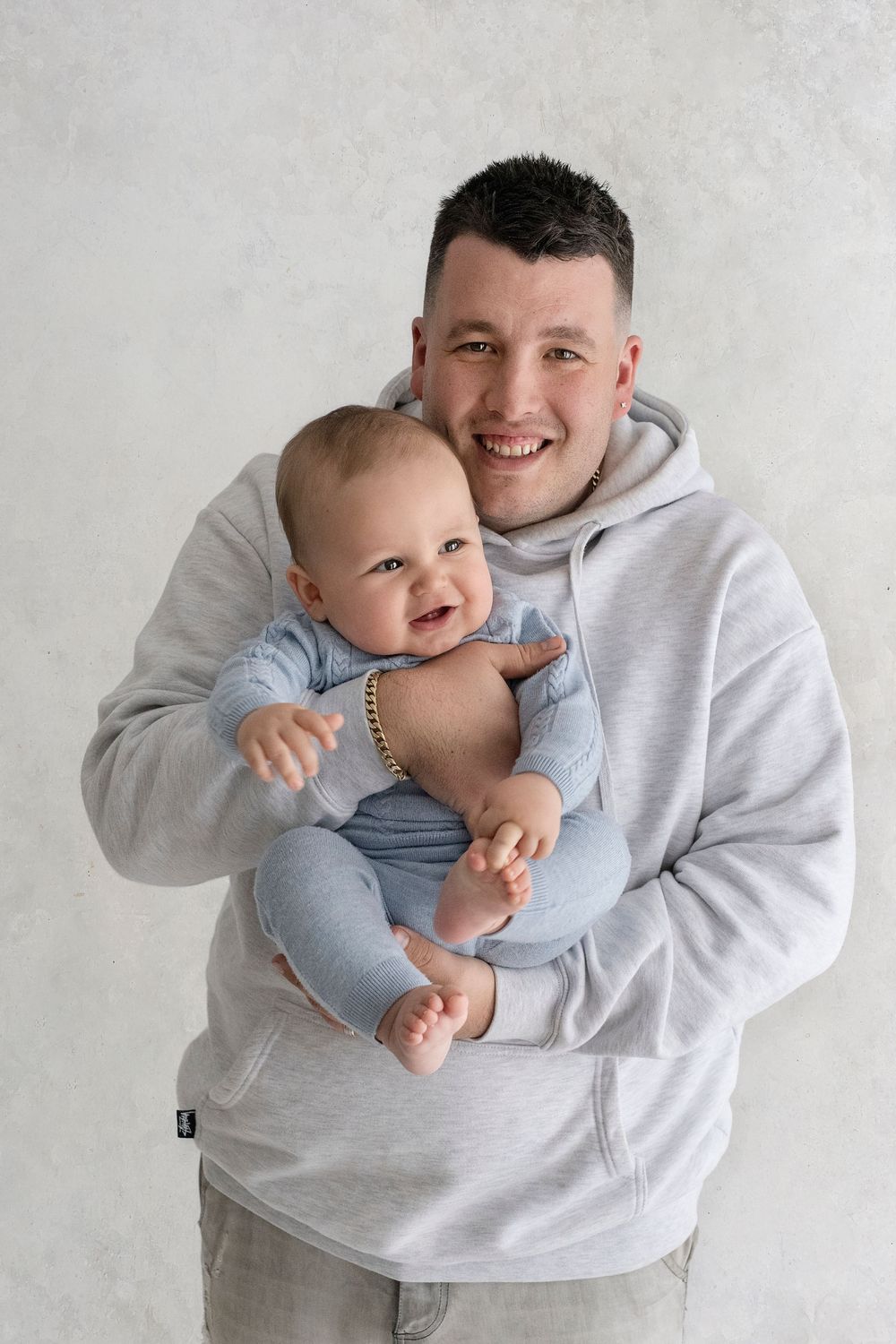 Sweet candid moments between father and son during a family photography session