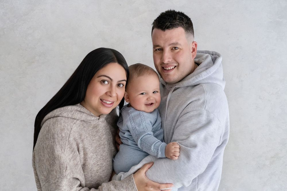 Intimate family portraits captured against a minimalist white background.