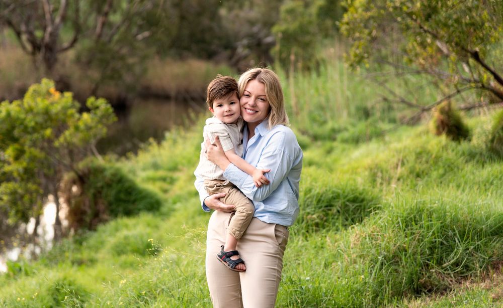 Family photoshoot sequence in natural outdoor setting with lush green grass and trees.