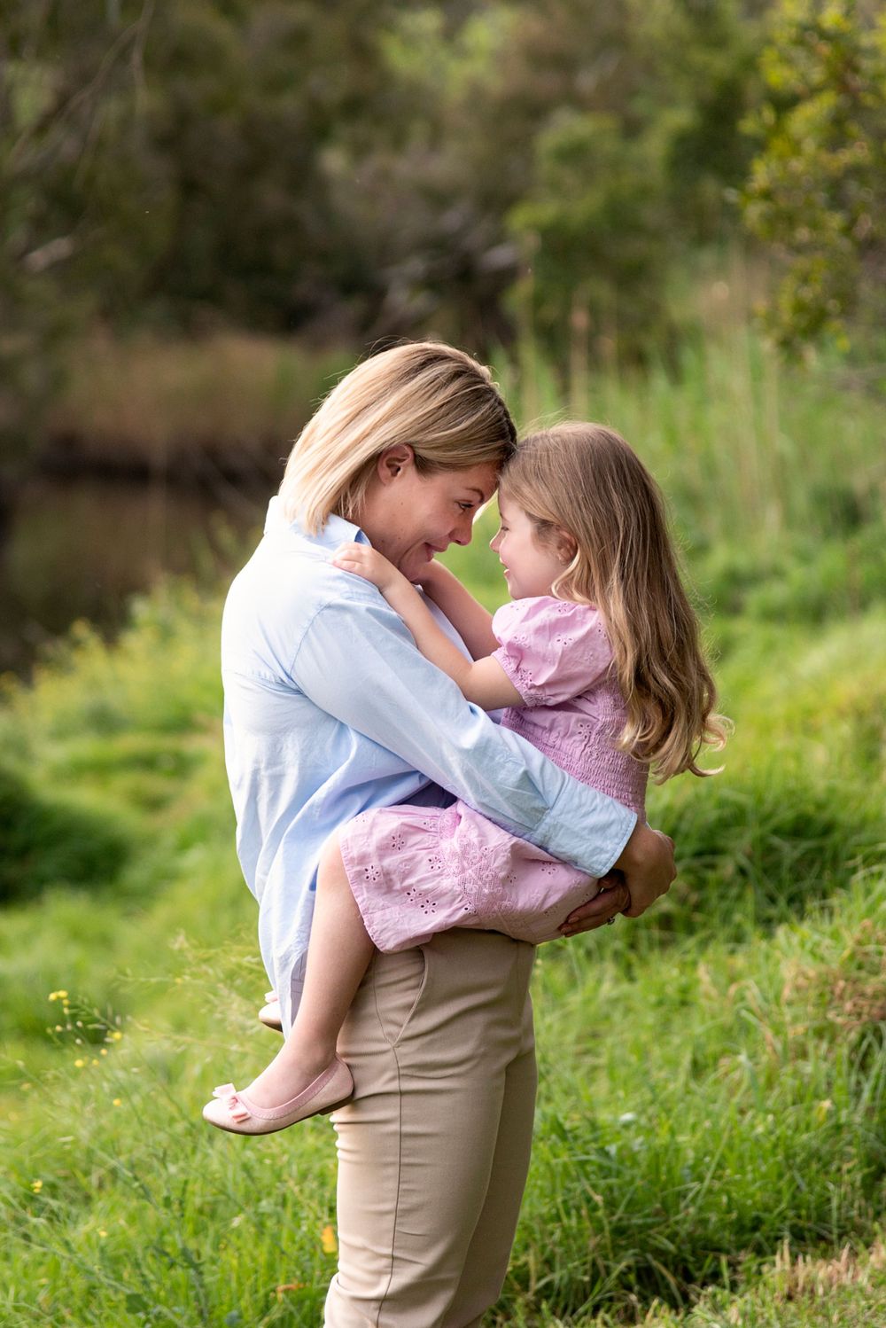 Sweet outdoor portrait series showing tender family moments in natural setting.
