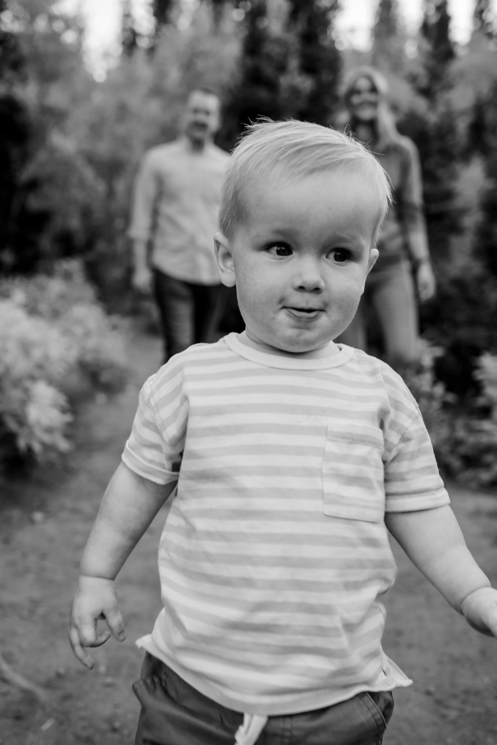 Baby wearing striped shirt in black and white outdoor portrait series.