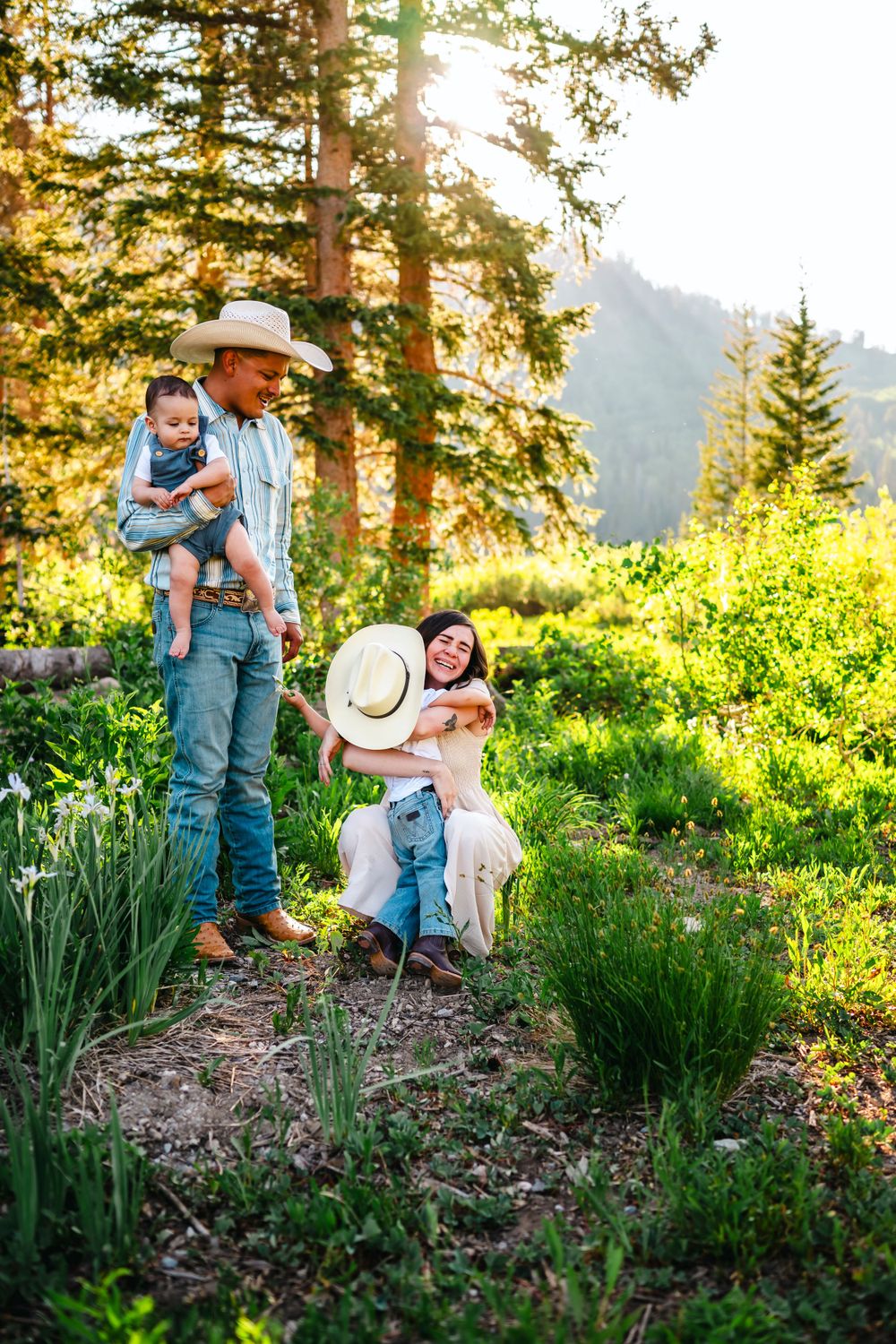 Family sharing tender moments in a mountain garden setting during golden hour.