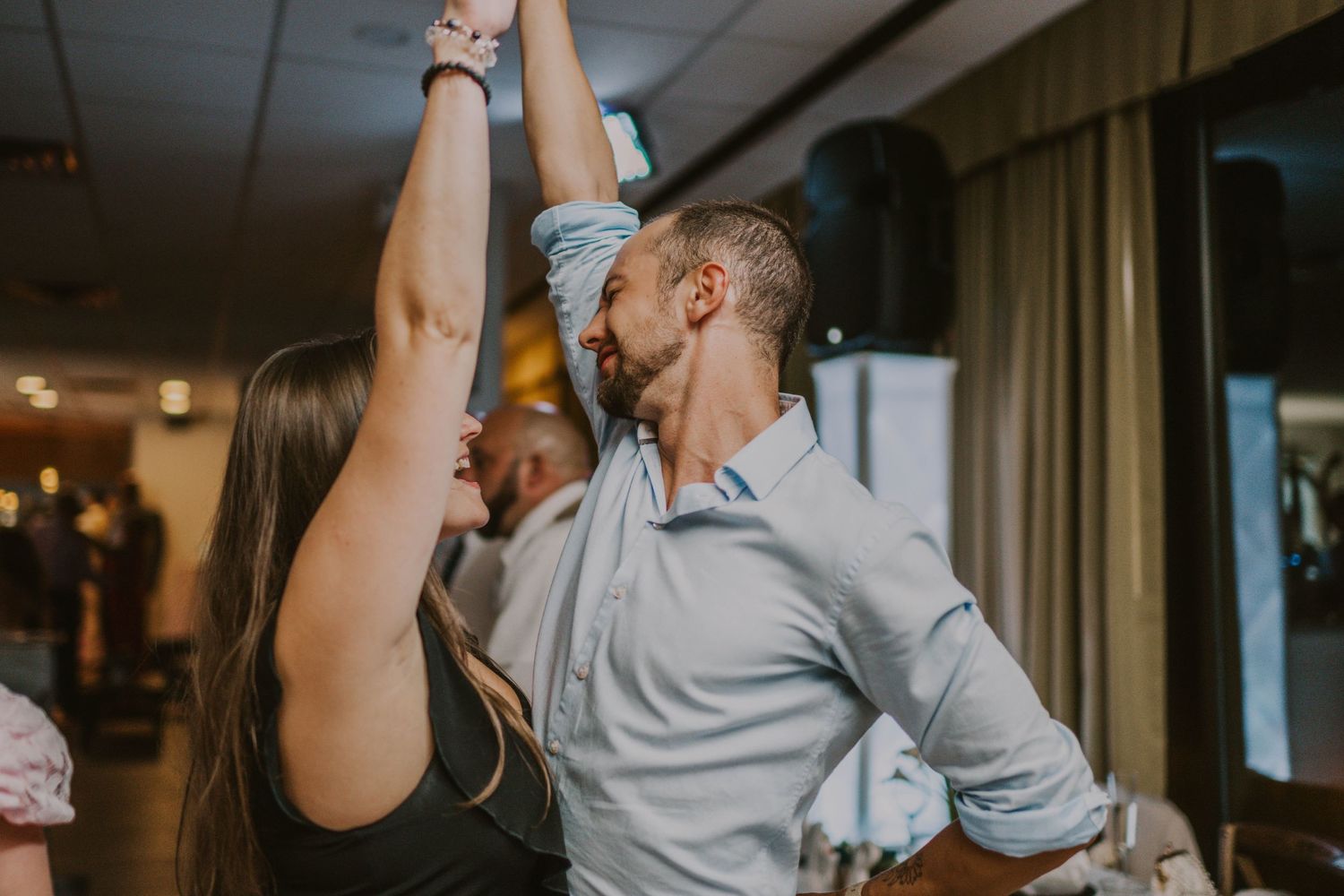 Couple sharing a romantic dance moment in an indoor setting.