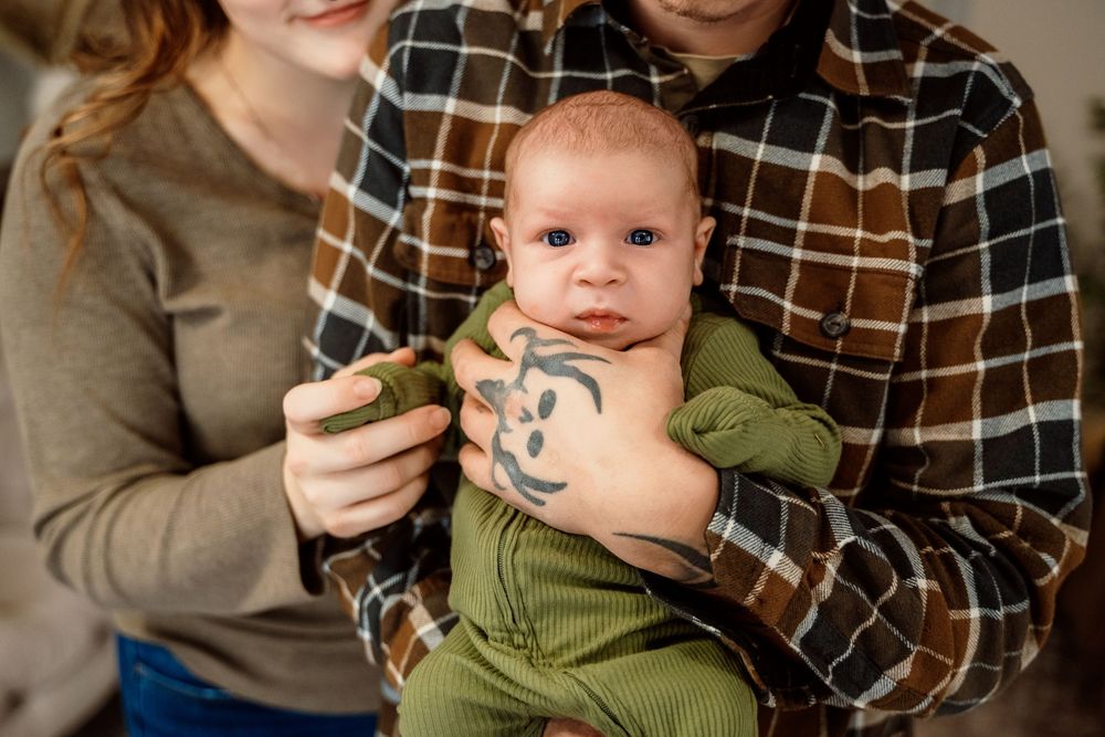 A series of photos showing a baby in a green hoodie being held and cuddled.
