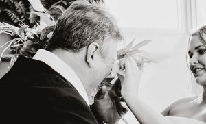 Intimate wedding ceremony moment captured in black and white photography.