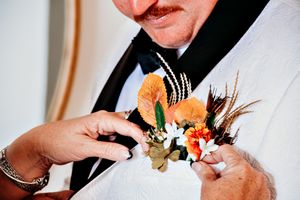 Close-up of hands signing wedding documents with pen and paper.