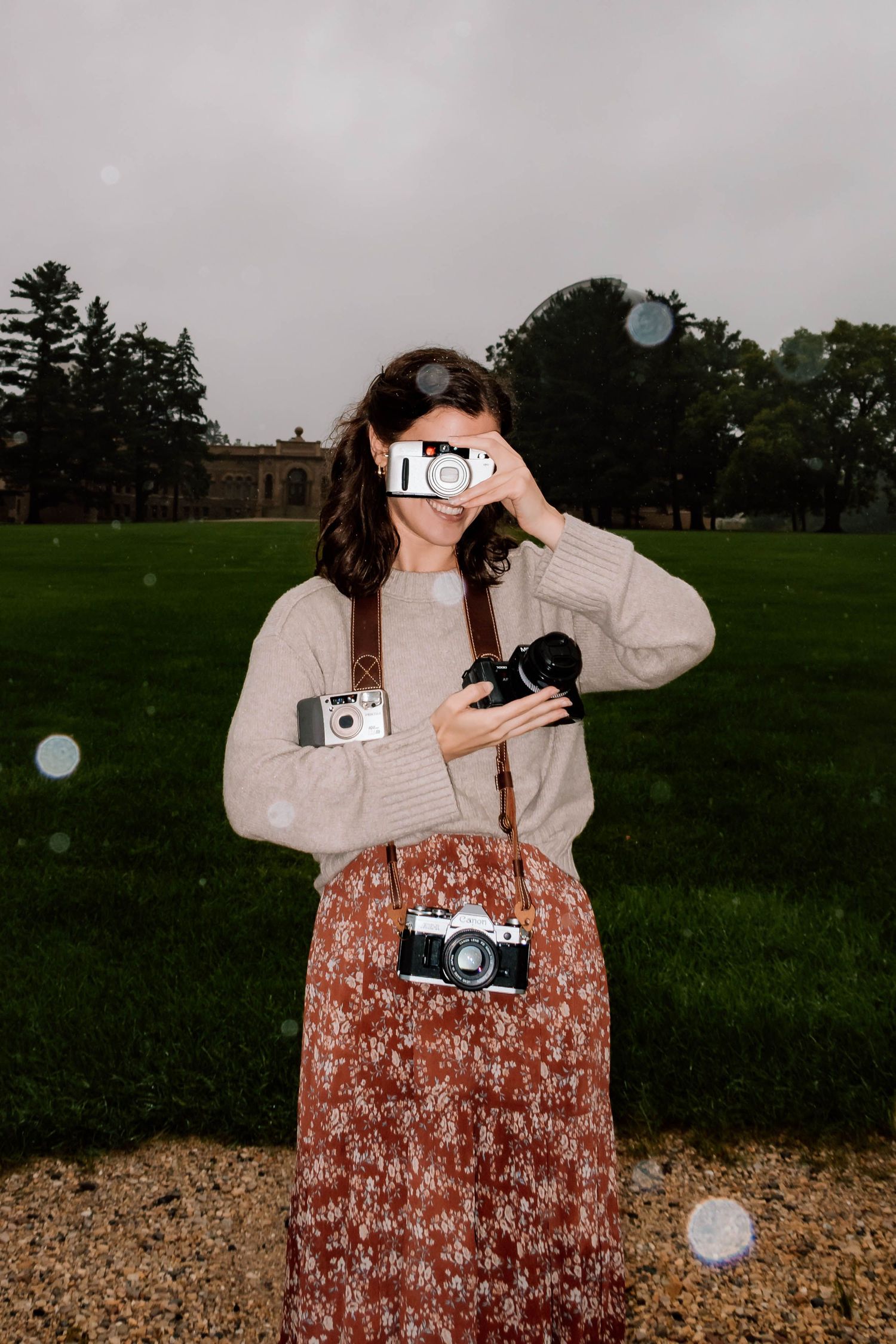 Naomi holding 4 film cameras