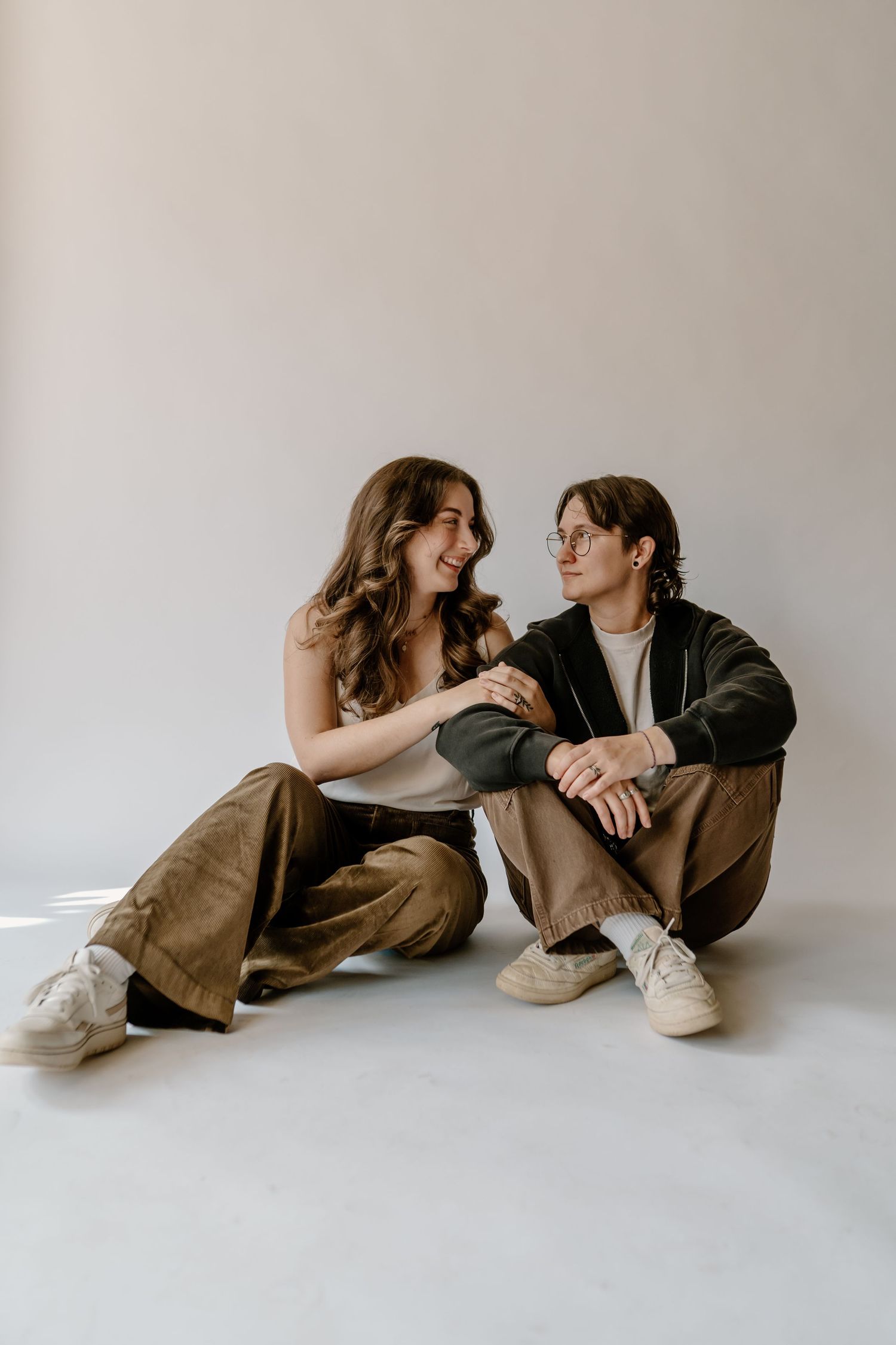two people sitting on concrete parking deck