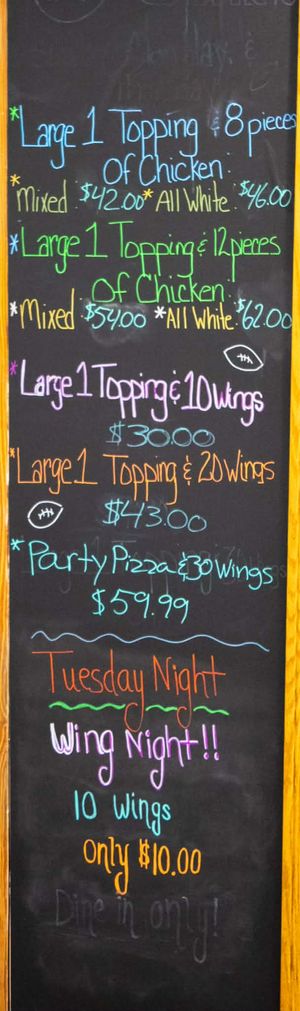 Chalkboard menu featuring pizza and wing combos, Tuesday Night Wing Night special, 10 wings for $10, dine-in only.