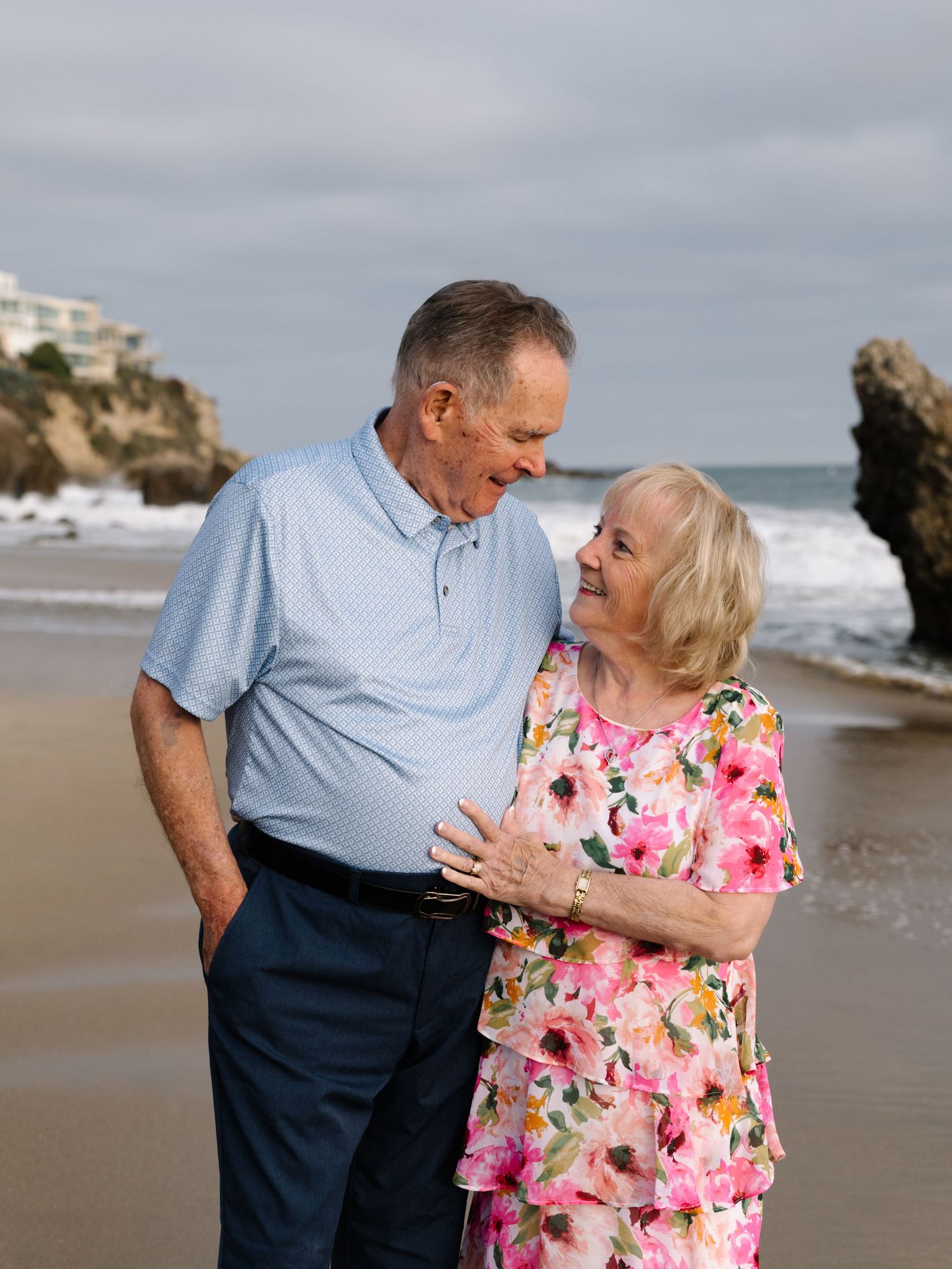 Grandparents sharing a moment on the beach during an extended family photography session.