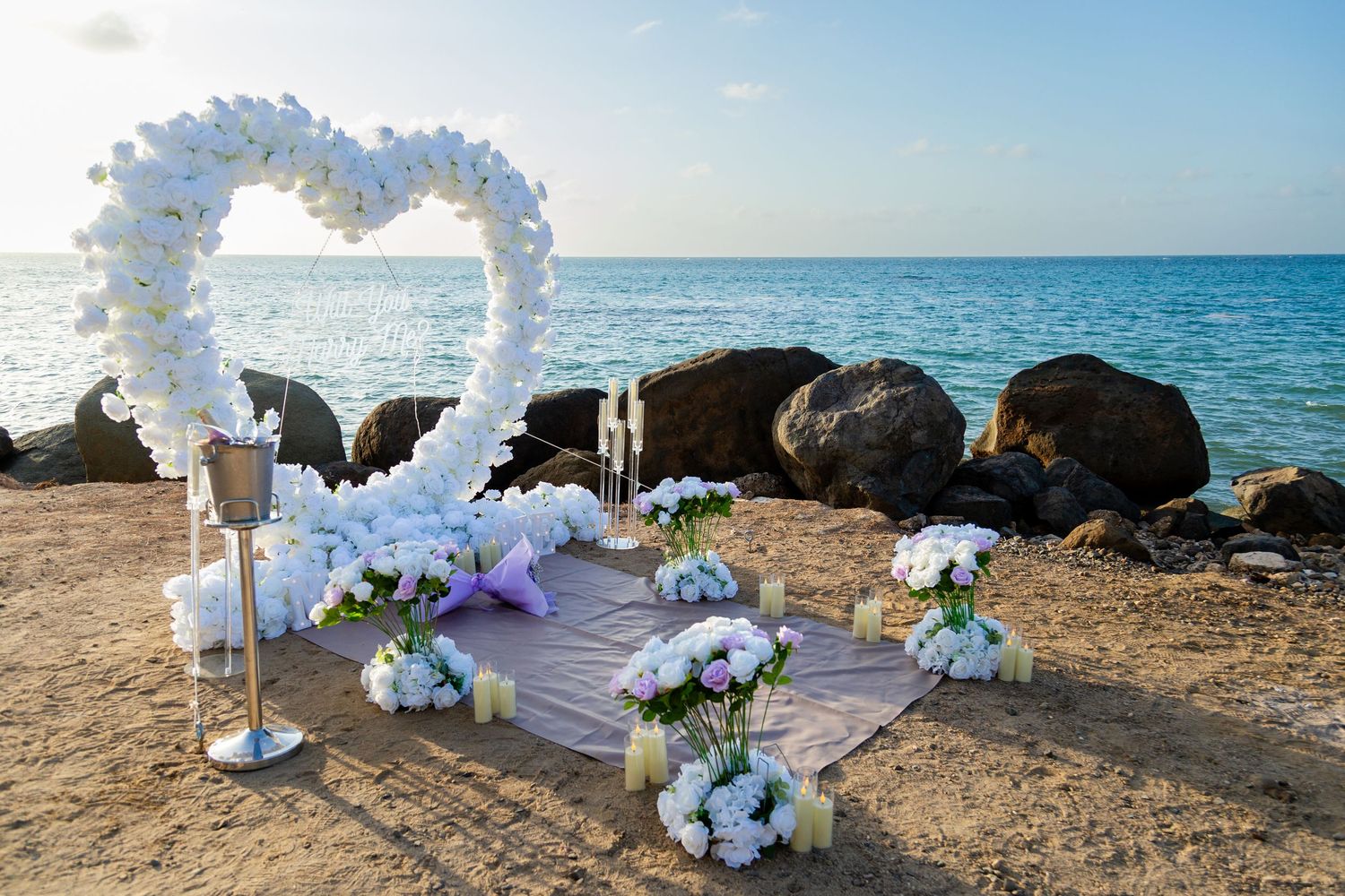 Marriage proposal decorative setup with white flower heart overlooking the ocean in Río Grande, Puerto Rico.