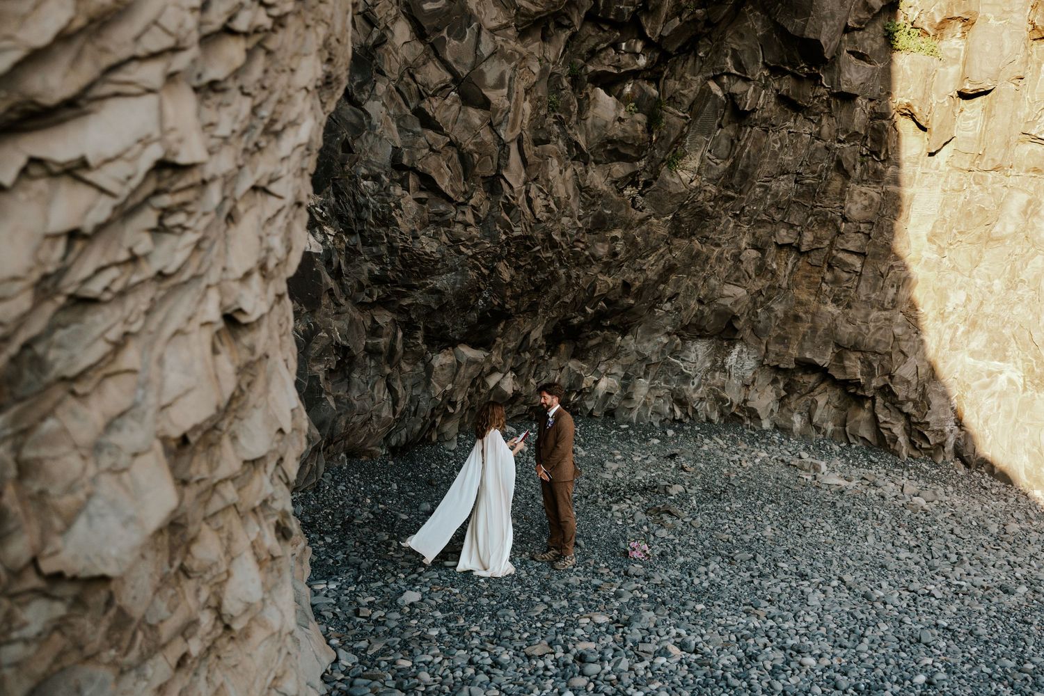 sweet moment of bride reading vows to groom at Reynisfjara Beach in iceland