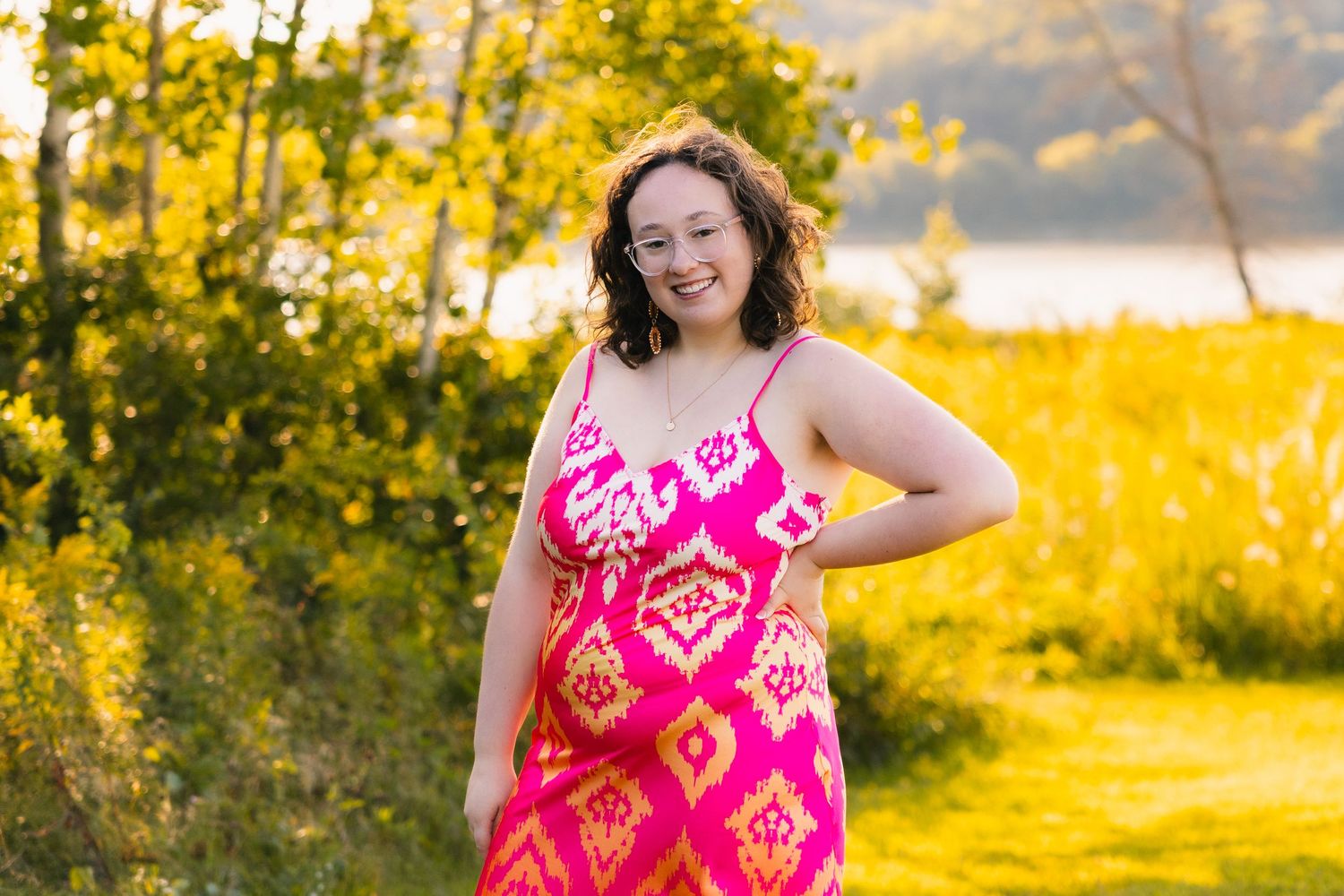 preparing for high school senior photoshoot tips and tricks madison wisconsin yearbook photos clean clothes vibrant pink silky dress nature