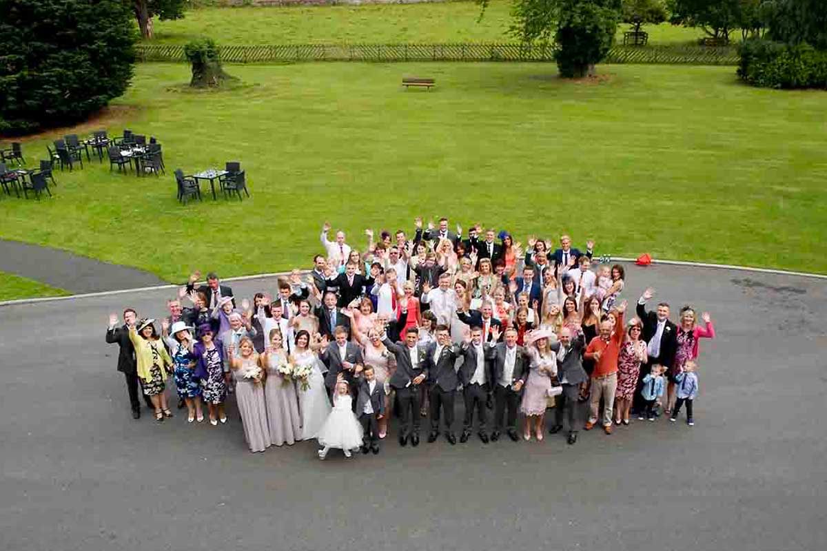 Wedding party pose in the car park at Greenhill Hotel