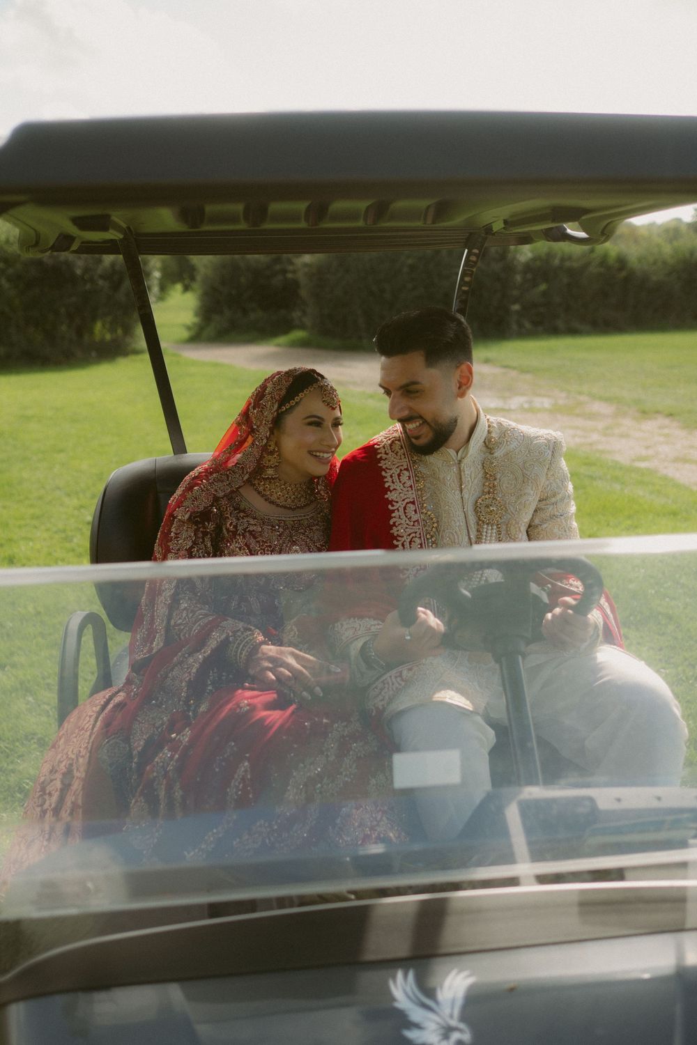 pakistani bride and groom in a golf cart during their couple shoot at the national golf course, Surrey.
