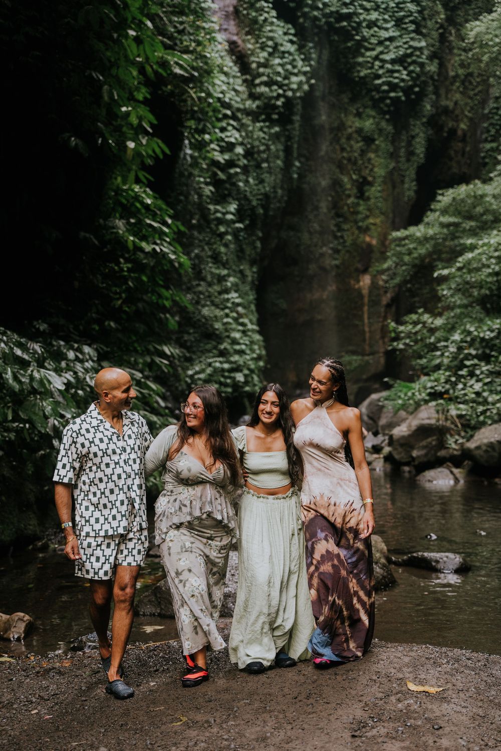 Natural family photography surrounded by tropical greenery at Sekumpul Waterfall