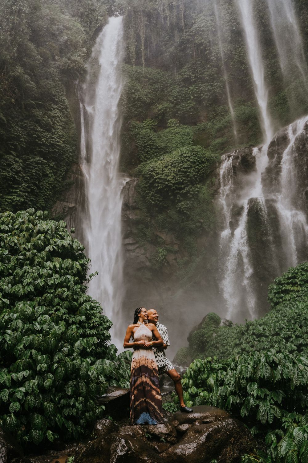Natural family photography surrounded by tropical greenery at Sekumpul Waterfall