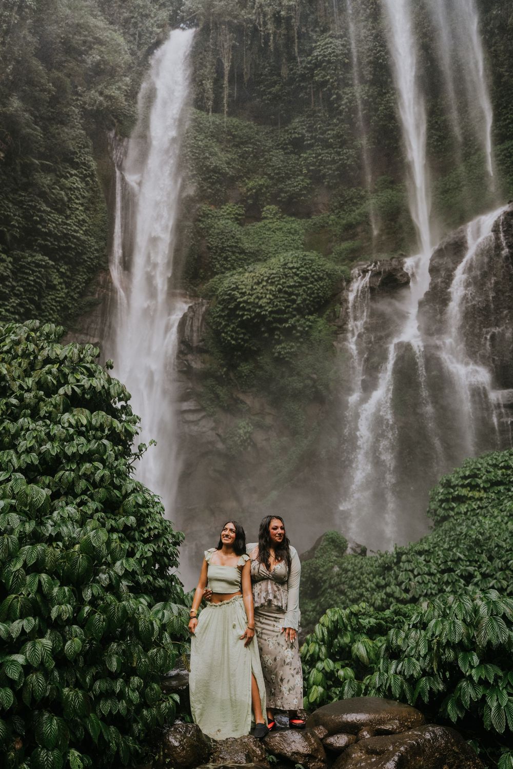 Natural family photography surrounded by tropical greenery at Sekumpul Waterfall