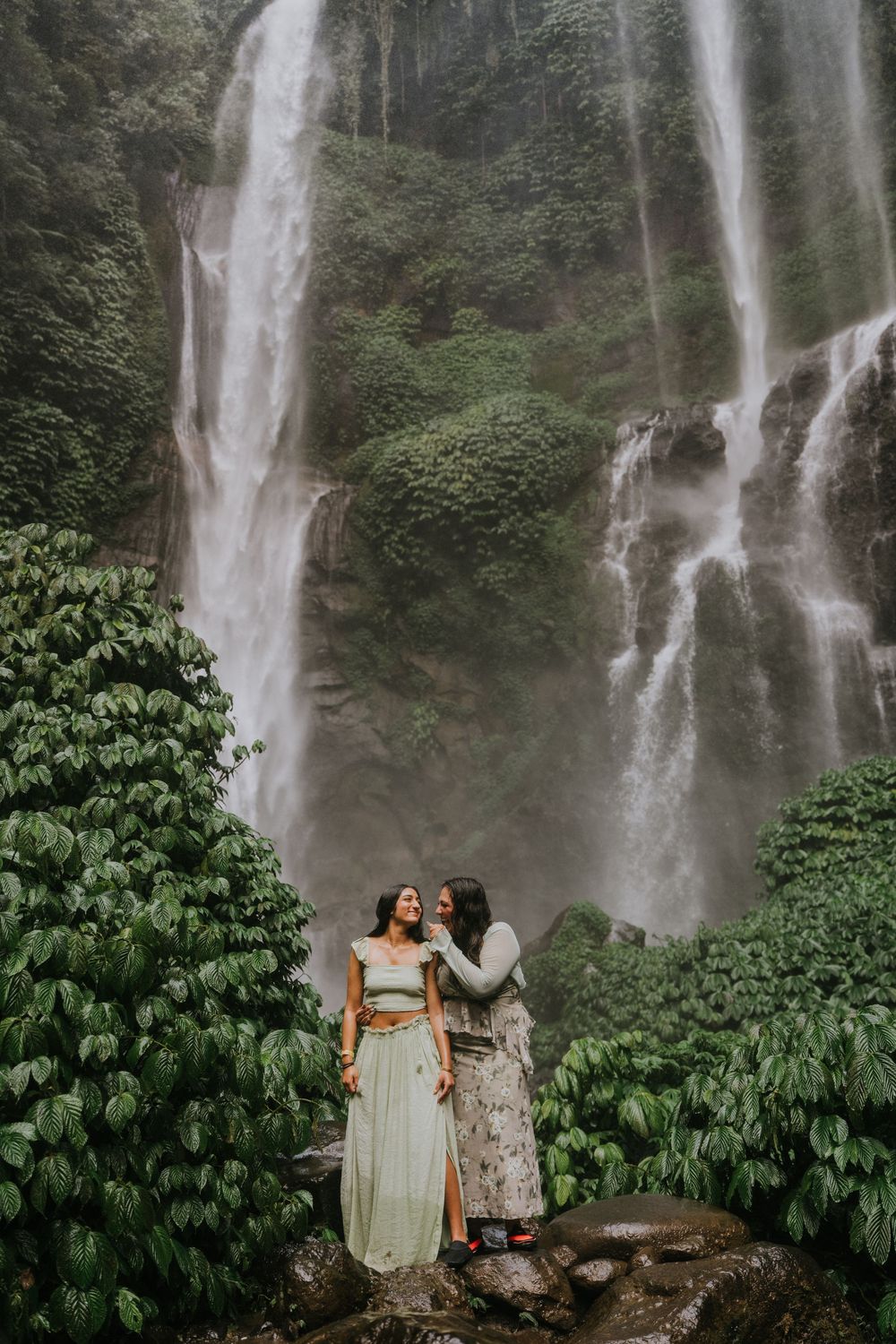 Natural family photography surrounded by tropical greenery at Sekumpul Waterfall