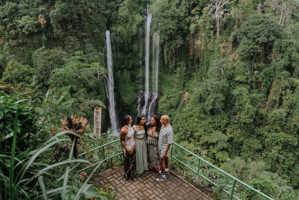 Natural family photography surrounded by tropical greenery at Sekumpul Waterfall
