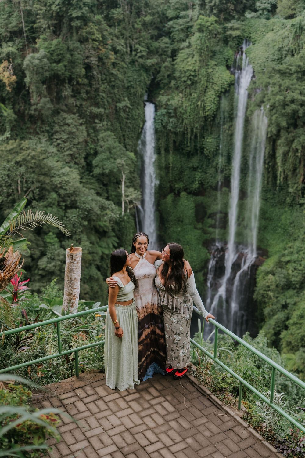 Natural family photography surrounded by tropical greenery at Sekumpul Waterfall