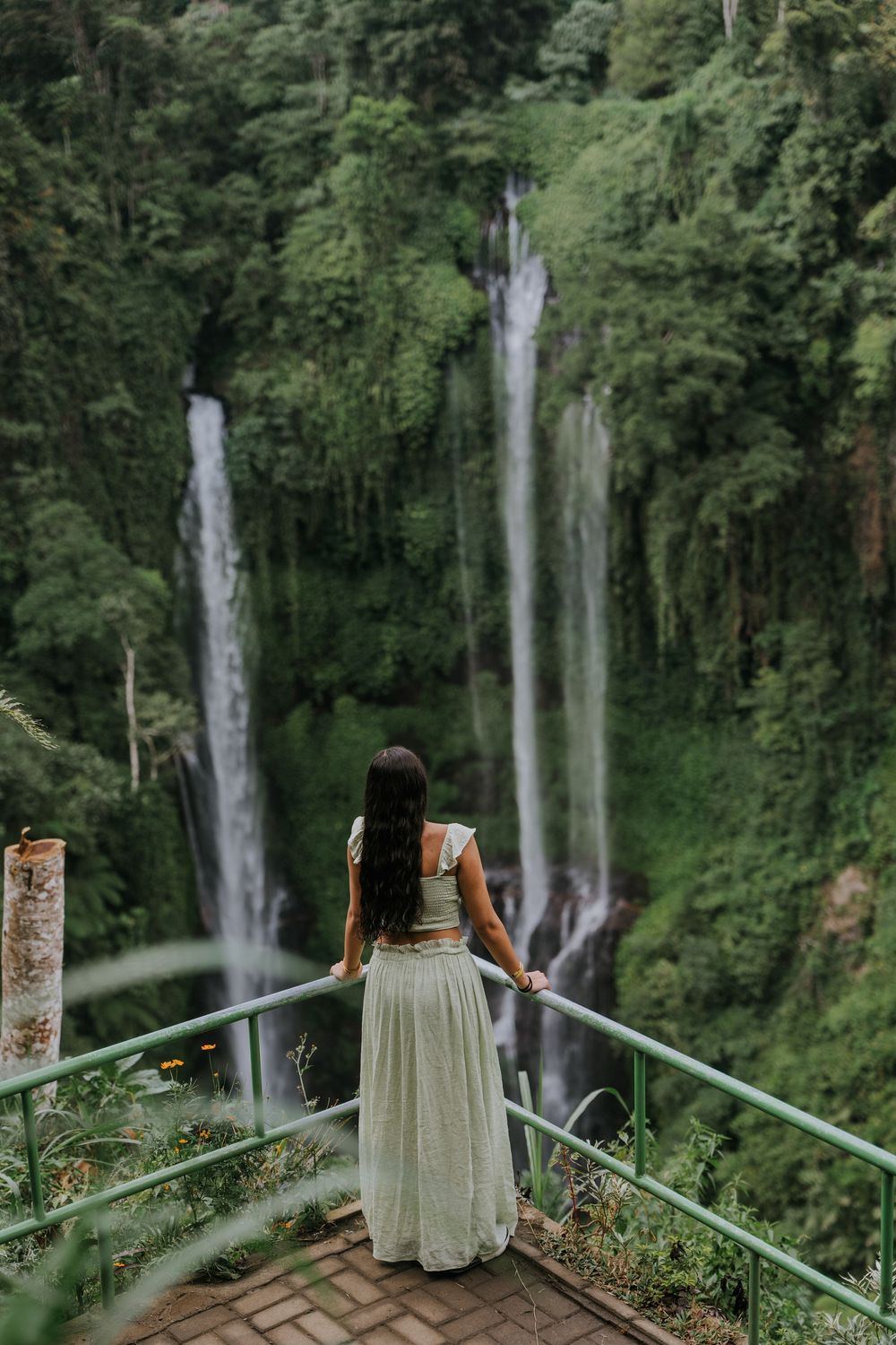 Natural family photography surrounded by tropical greenery at Sekumpul Waterfall