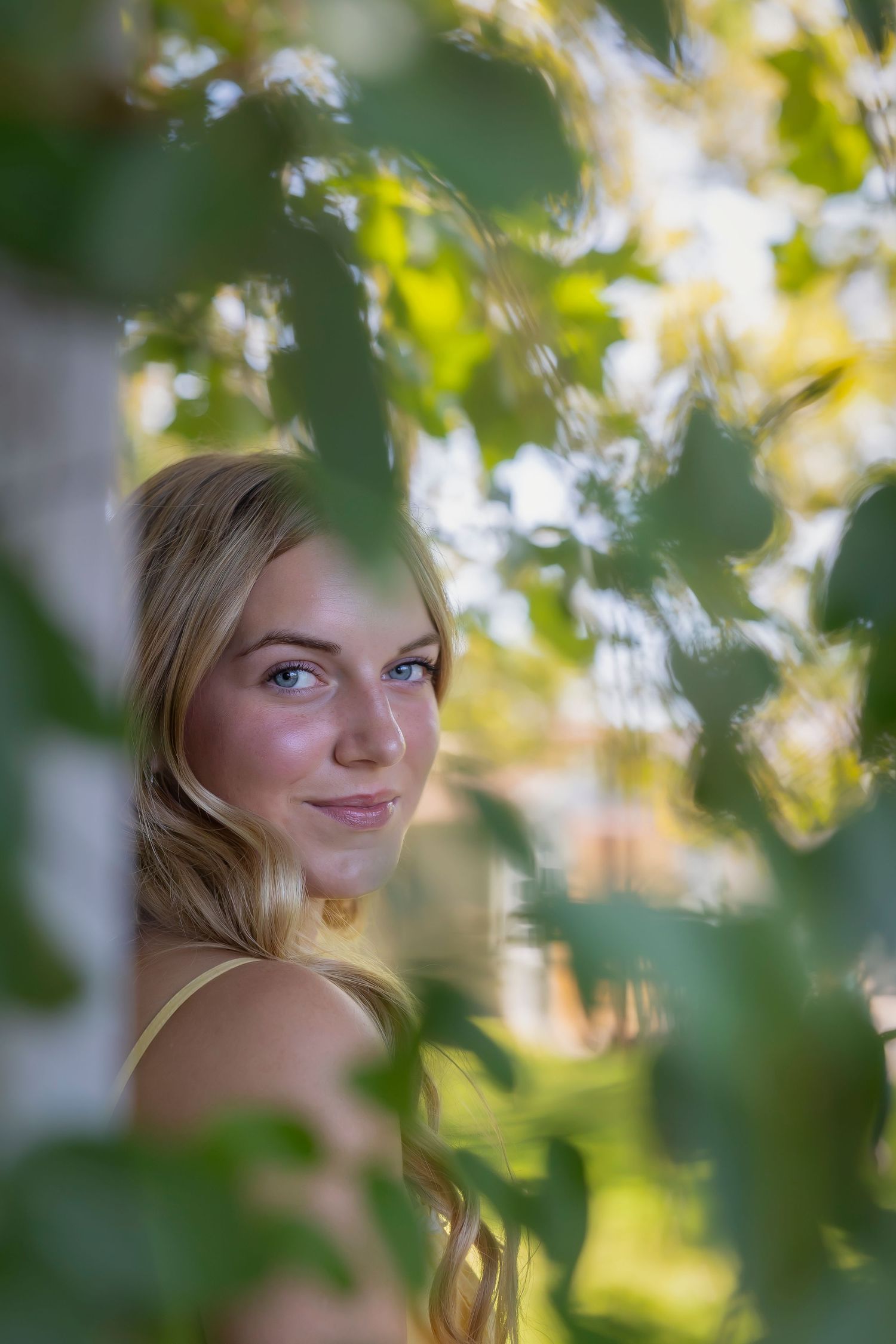 portrait of girl through greenery