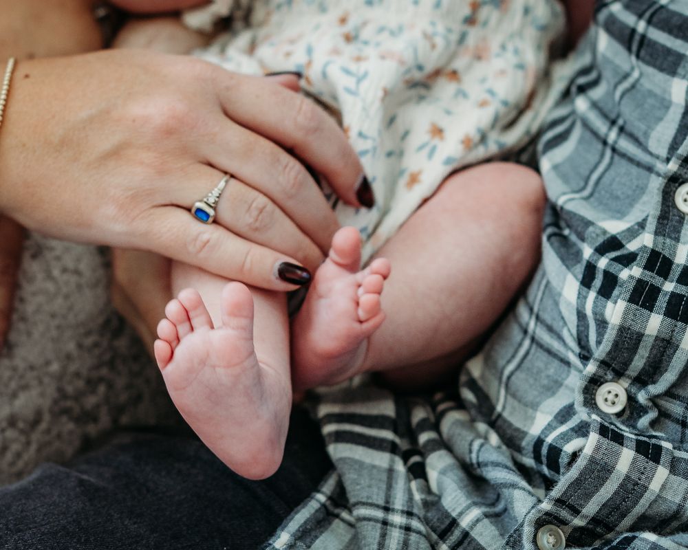 Close-up of newborn baby’s tiny feet during a lifestyle newborn photography session.