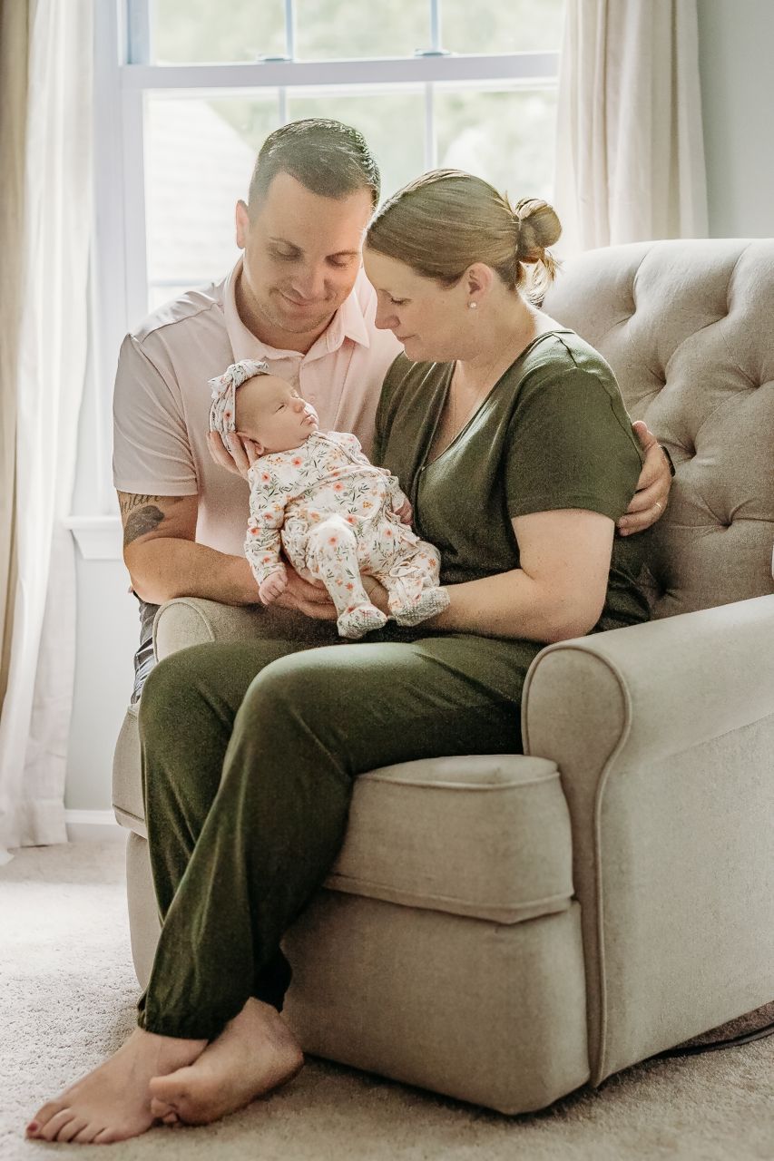Parents cuddling their newborn baby together during a South Jersey lifestyle newborn session.