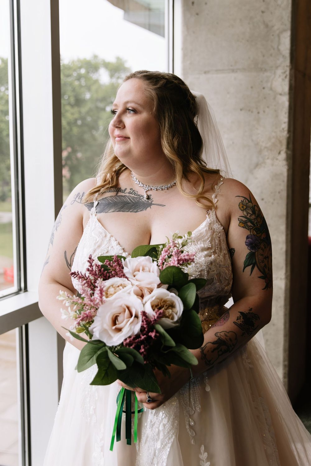 Three romantic bridal portraits showing a bouquet with pink magnolias against a light tulle gown by large windows.