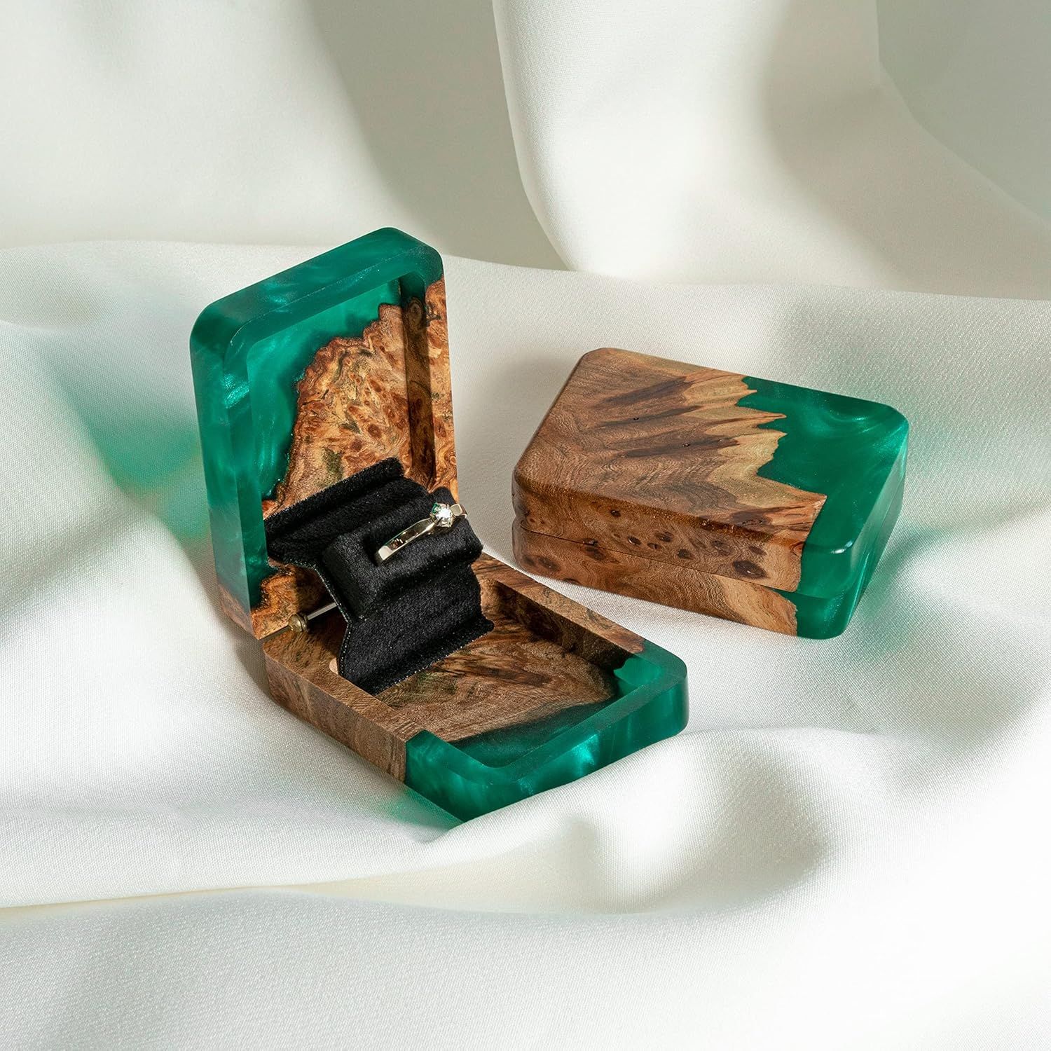 Handcrafted wooden rings with emerald green resin inlays shown from multiple angles on white background.