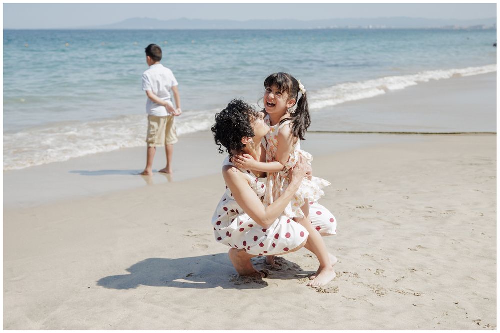 Hyatt Ziva Puerto Vallarta Family Photographer capturing a mother and daughter laughing together on the beach during Beach Family Photos