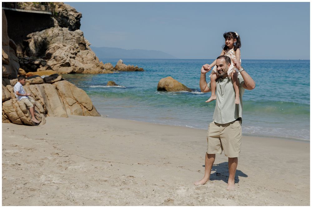 Hyatt Ziva Puerto Vallarta Family Photographer capturing a father carrying his daughter on the beach during Beach Family Photography.