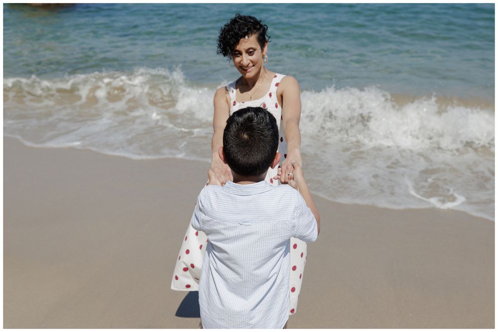 Hyatt Ziva Puerto Vallarta Family Photographer capturing a mother and son holding hands on the beach during Beach Family Photos.