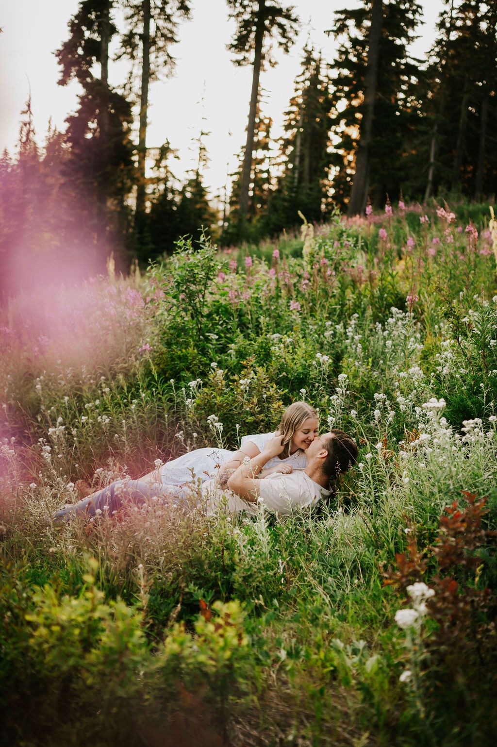 Couple laying in wild flower field Mt Washington Vancouver Island. Photography by Photographer Soulfull Photographs