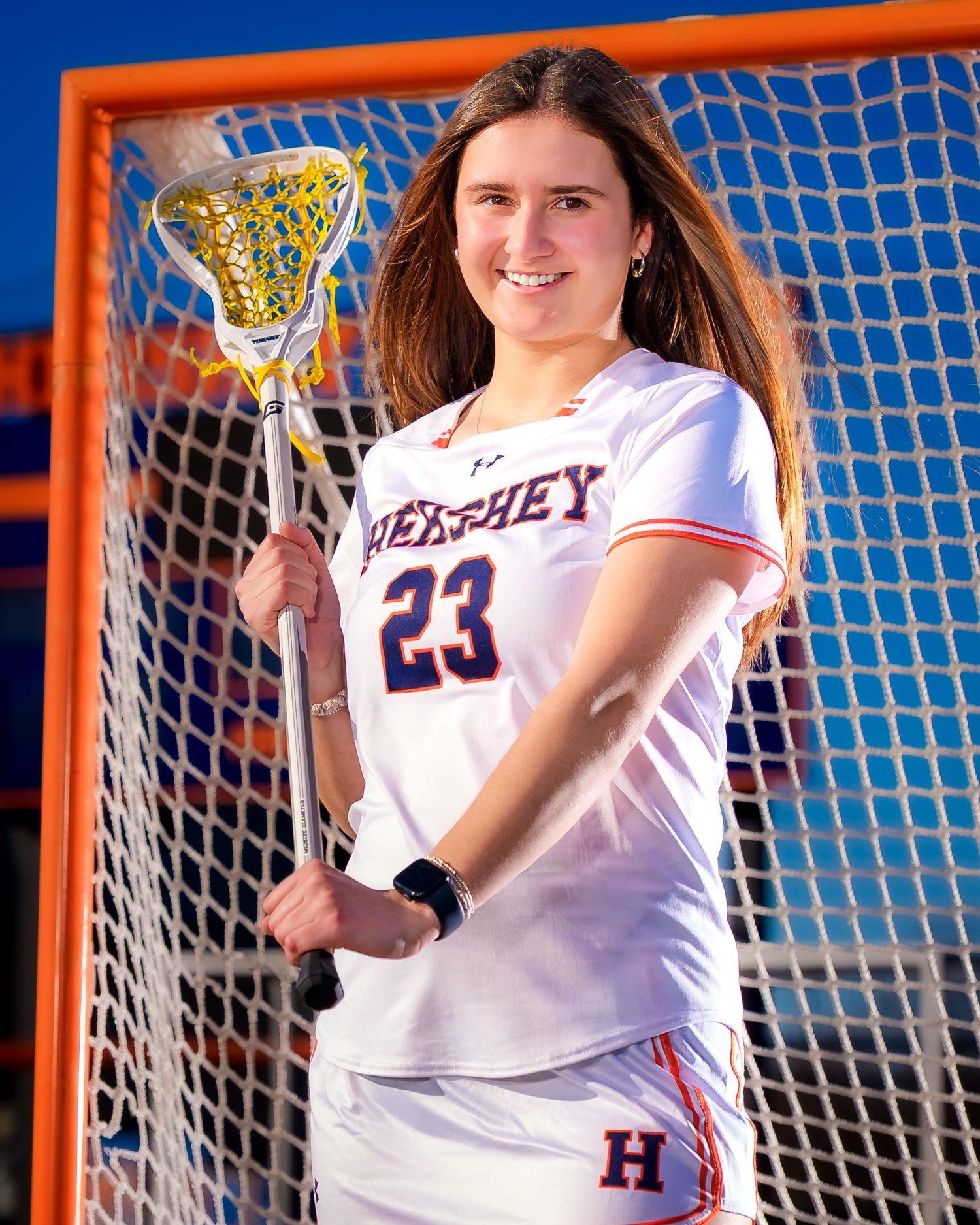 Hershey Trojans girls lacrosse player #23 photo day portrait at the goal, by Deanna Fox, SportsFox Photography based in Hershey PA