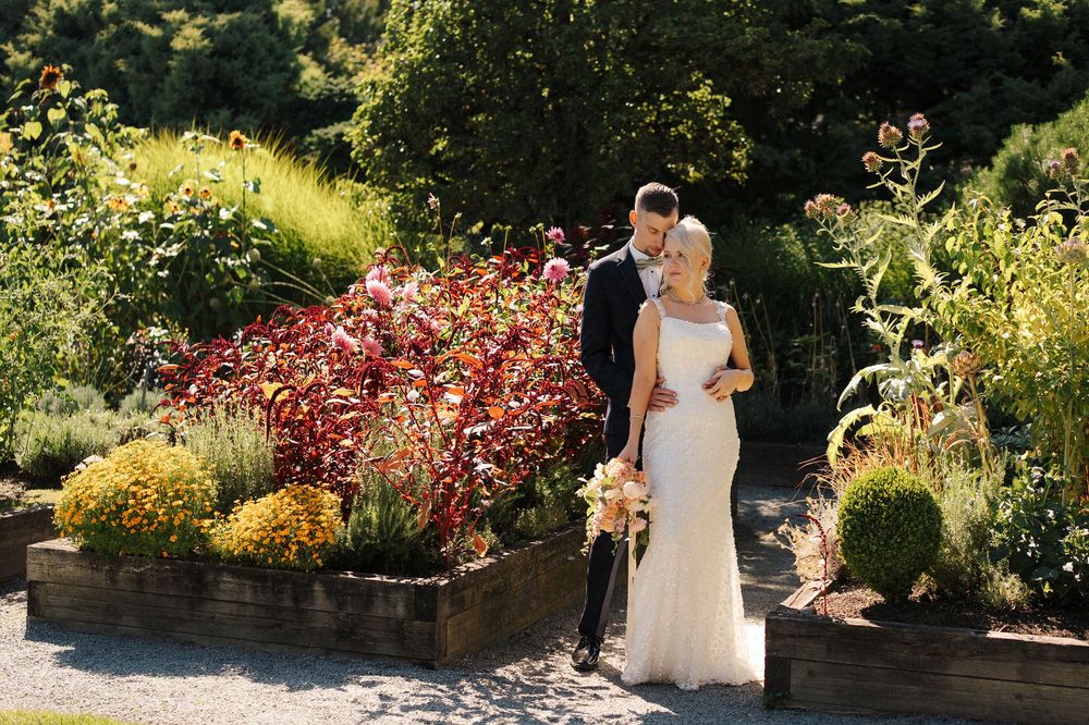 Bethany and Matt taking garden wedding portraits at Willows Lodge.