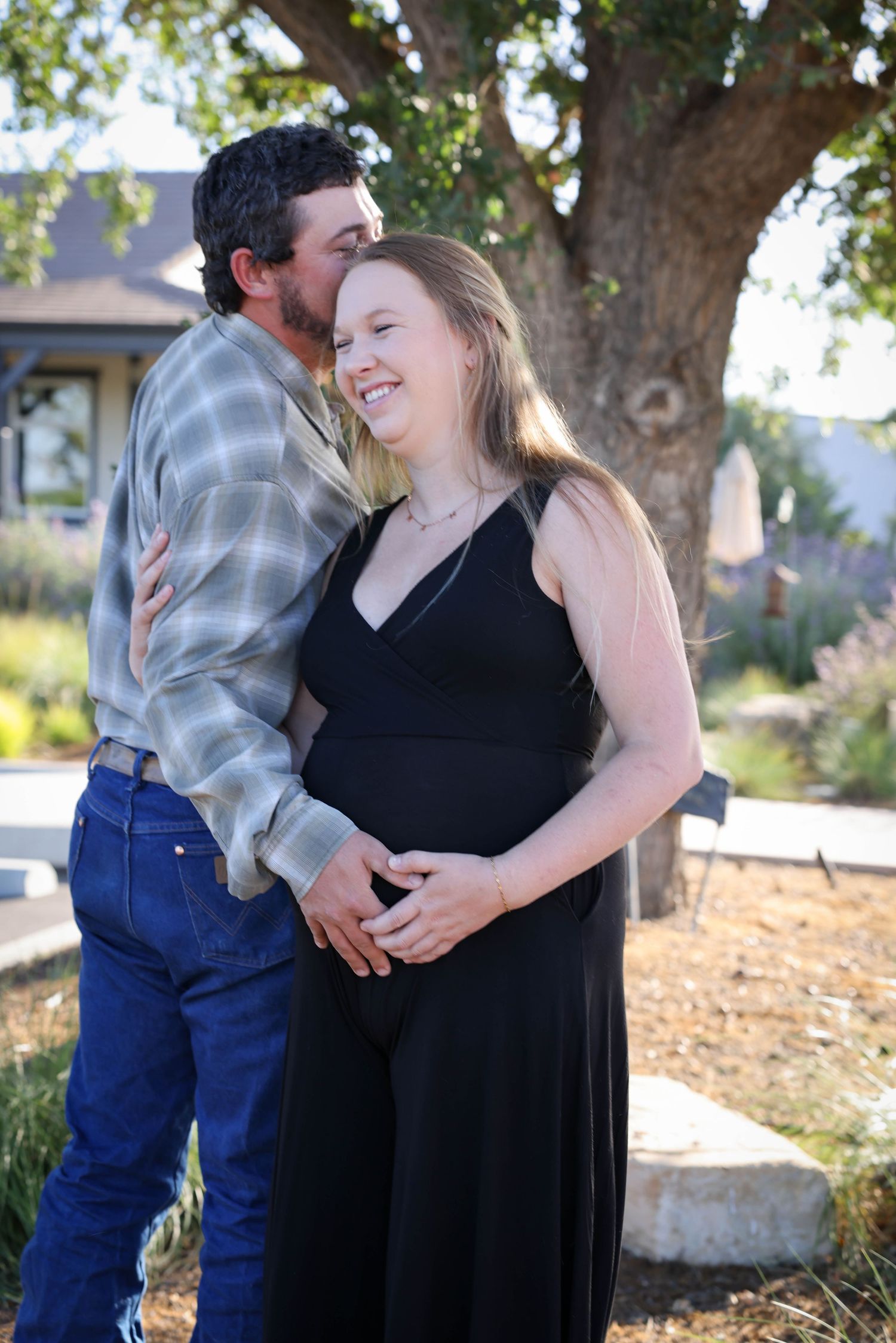 Couple shares an embrace under an oak tree in Paso Robles California