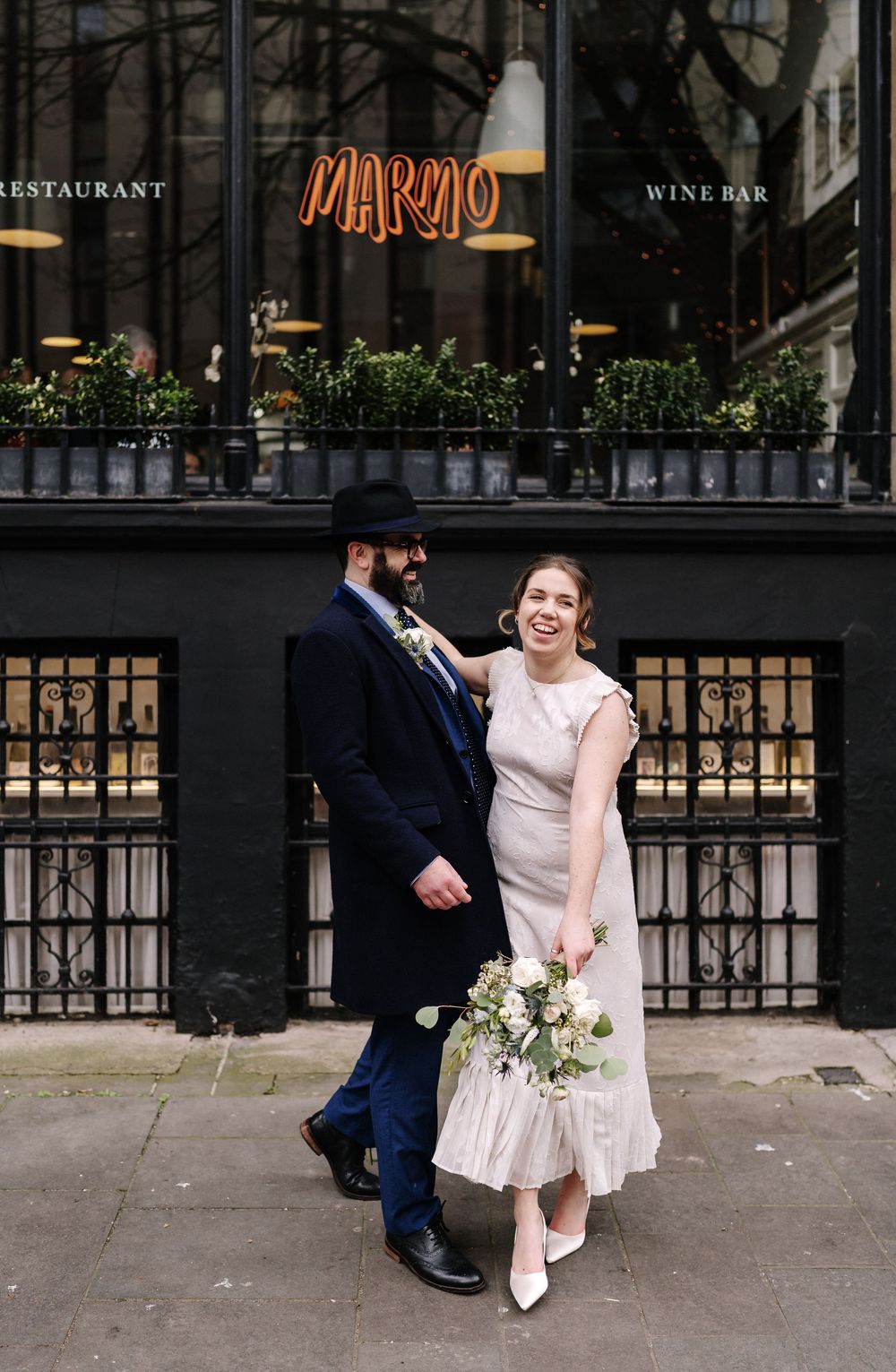 Newlyweds sharing a quiet moment outside Bristol Registry Office on Corn Street, Bristol.