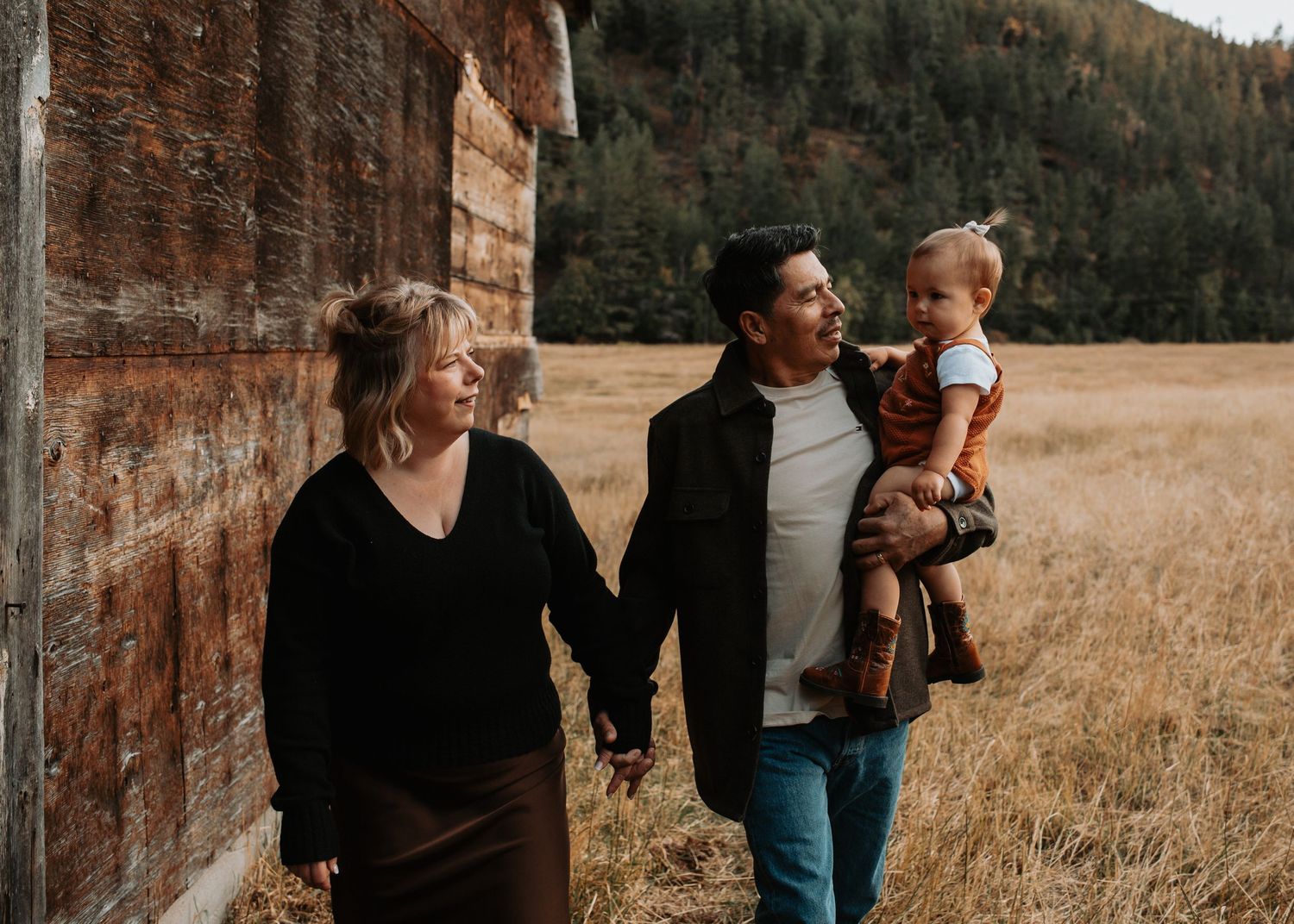 Grandparents walking hand in hand with their baby during a fall family photo session in the South Okanagan.