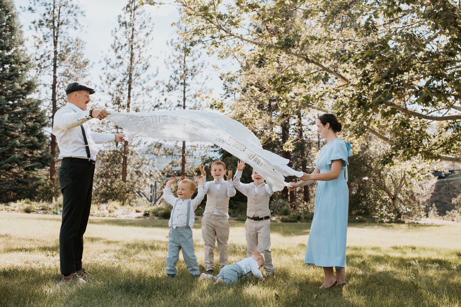 Generations family portrait surrounded by blooming roses during a South Okanagan family photography session.