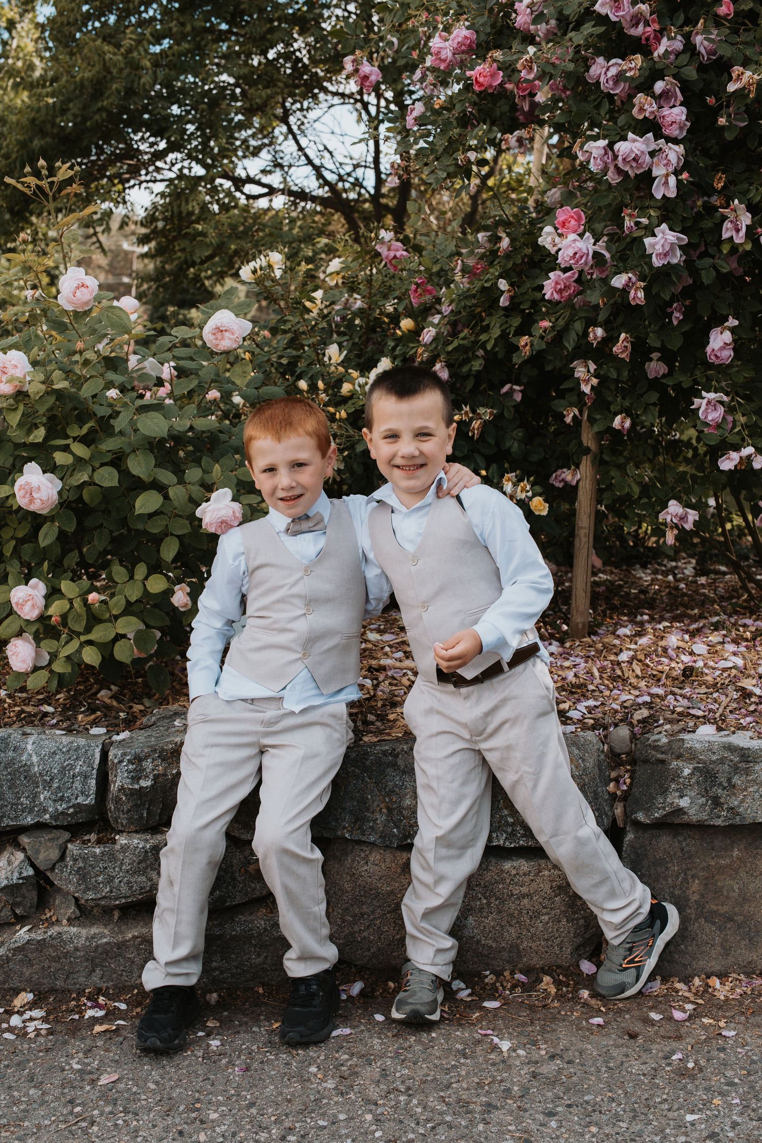 Brothers in South Okanagan generations photography session featuring multiple family members in a natural garden setting.