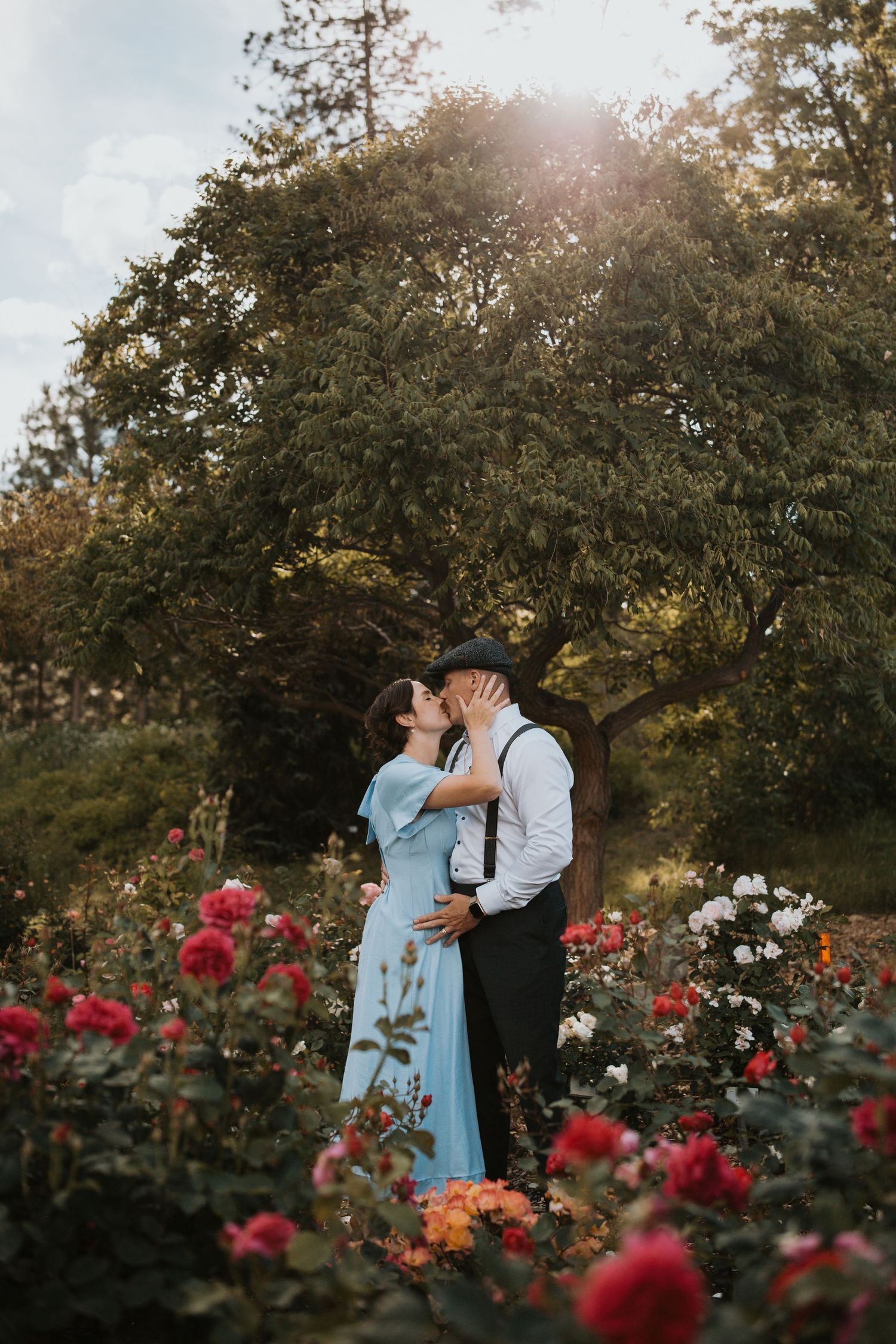Kissing mom and dad in family photo surrounded by flowers in the South Okanagan