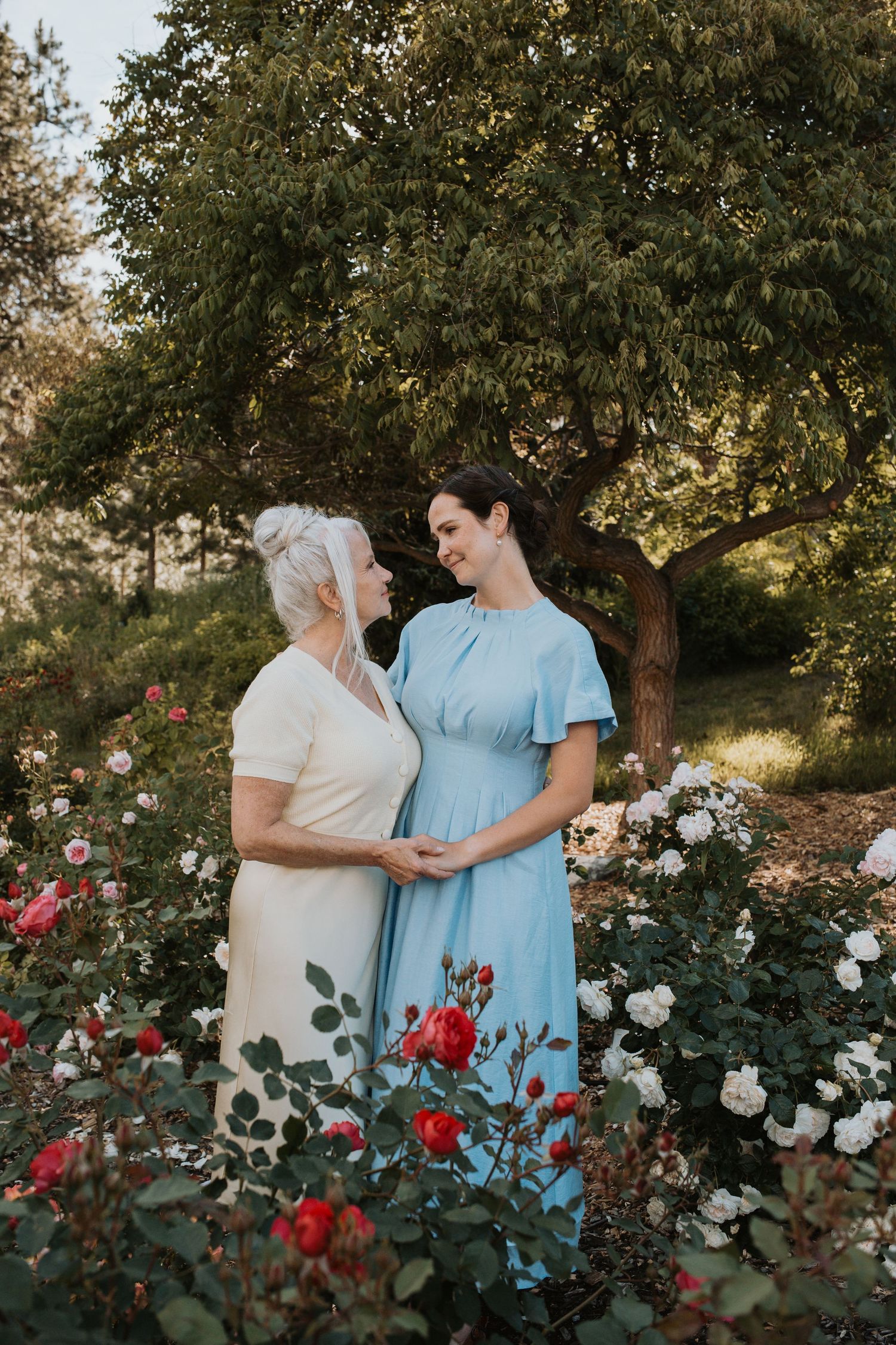 Mom & Daughter Generations family portrait surrounded by blooming roses during a South Okanagan family photography session.