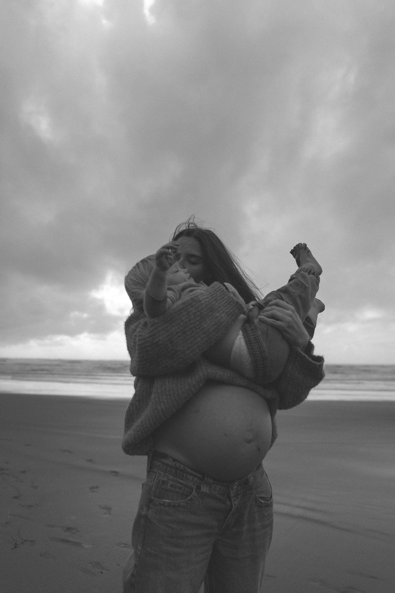 Pregnant mother holding her toddler close for a natural motherhood portrait in Waikato, New Zealand