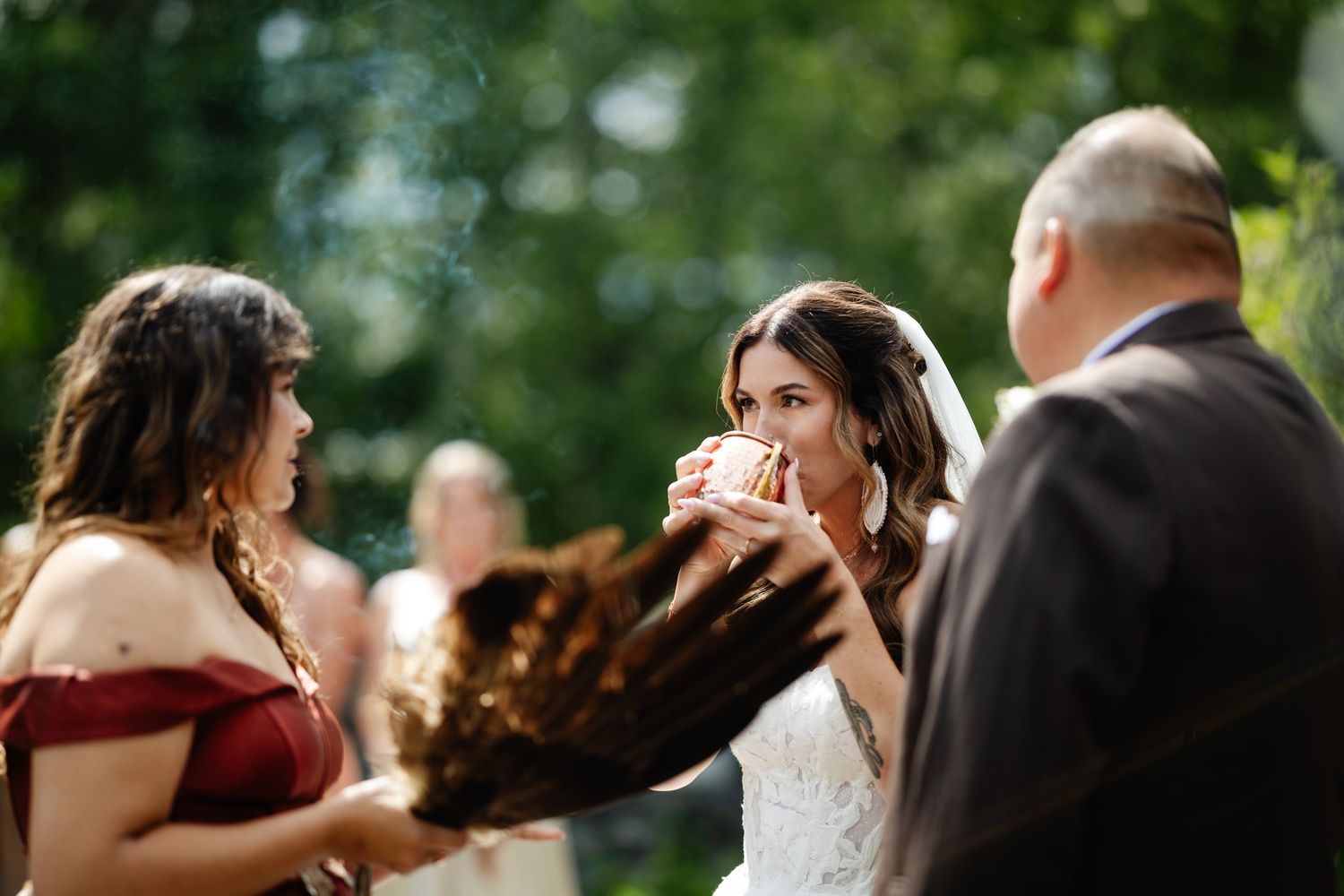 Feather smudge blessing during Azuridge wedding ceremony